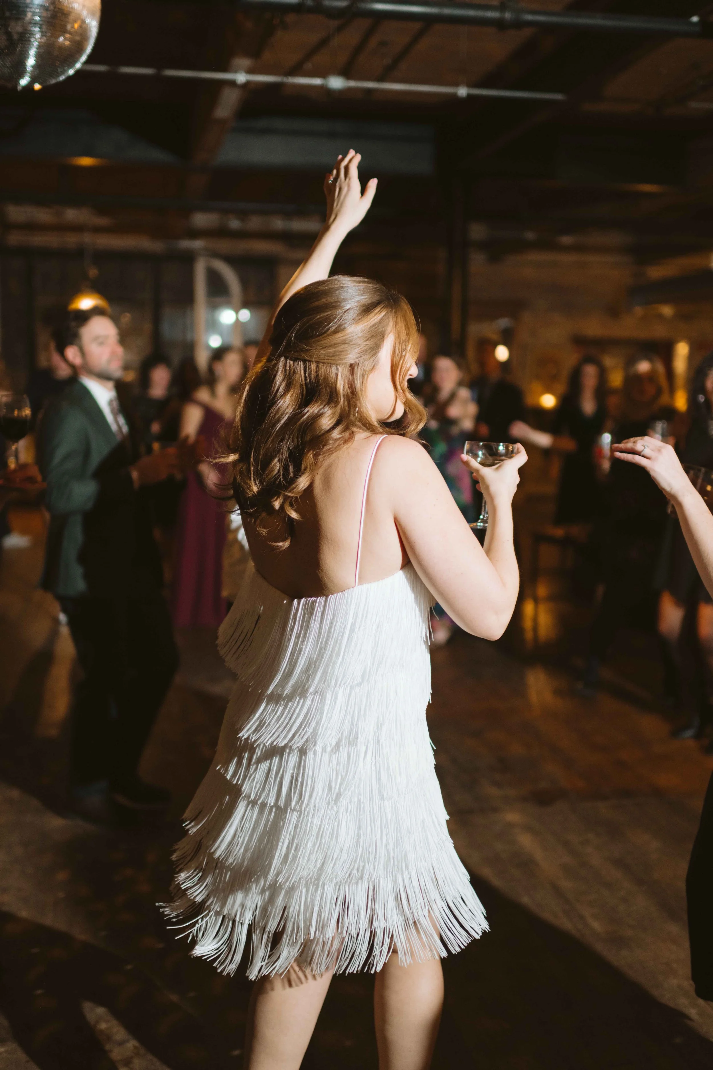 salvage one chicago wedding reception bride with her dress change white dress with fringe