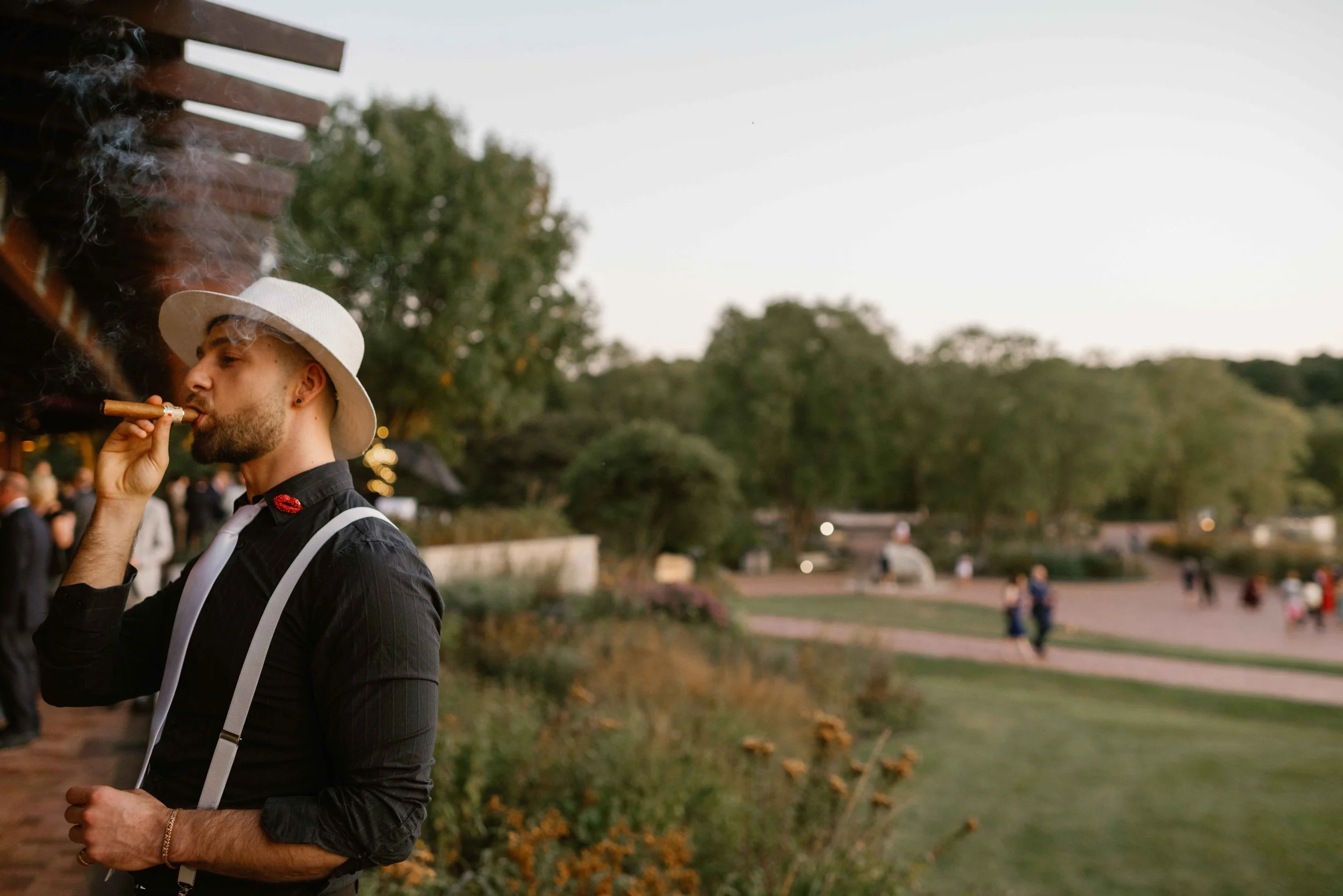 Guest smoking cigar at wedding