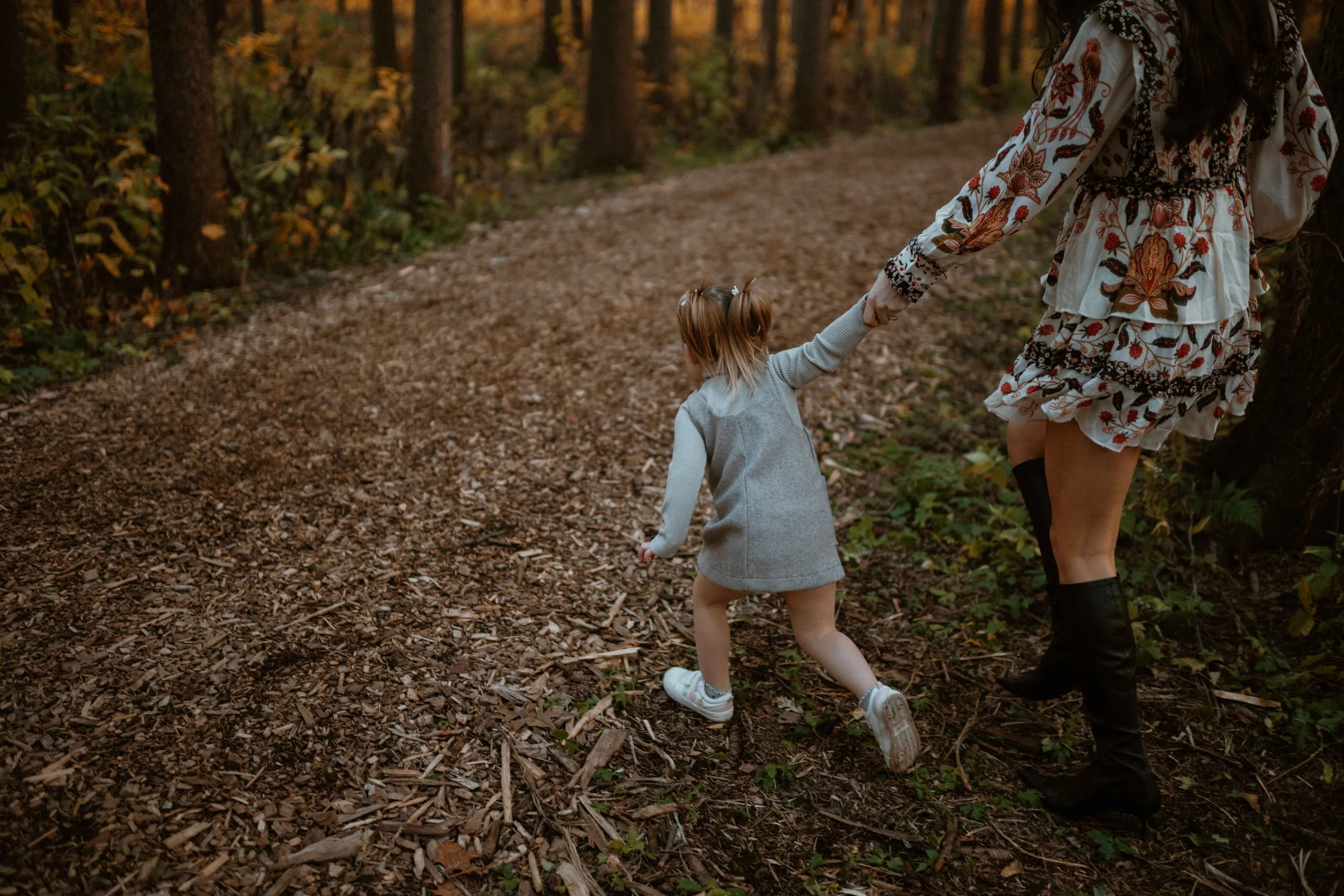 daugher dragging mama on walk at Morton Arboretum Lisle IL 
