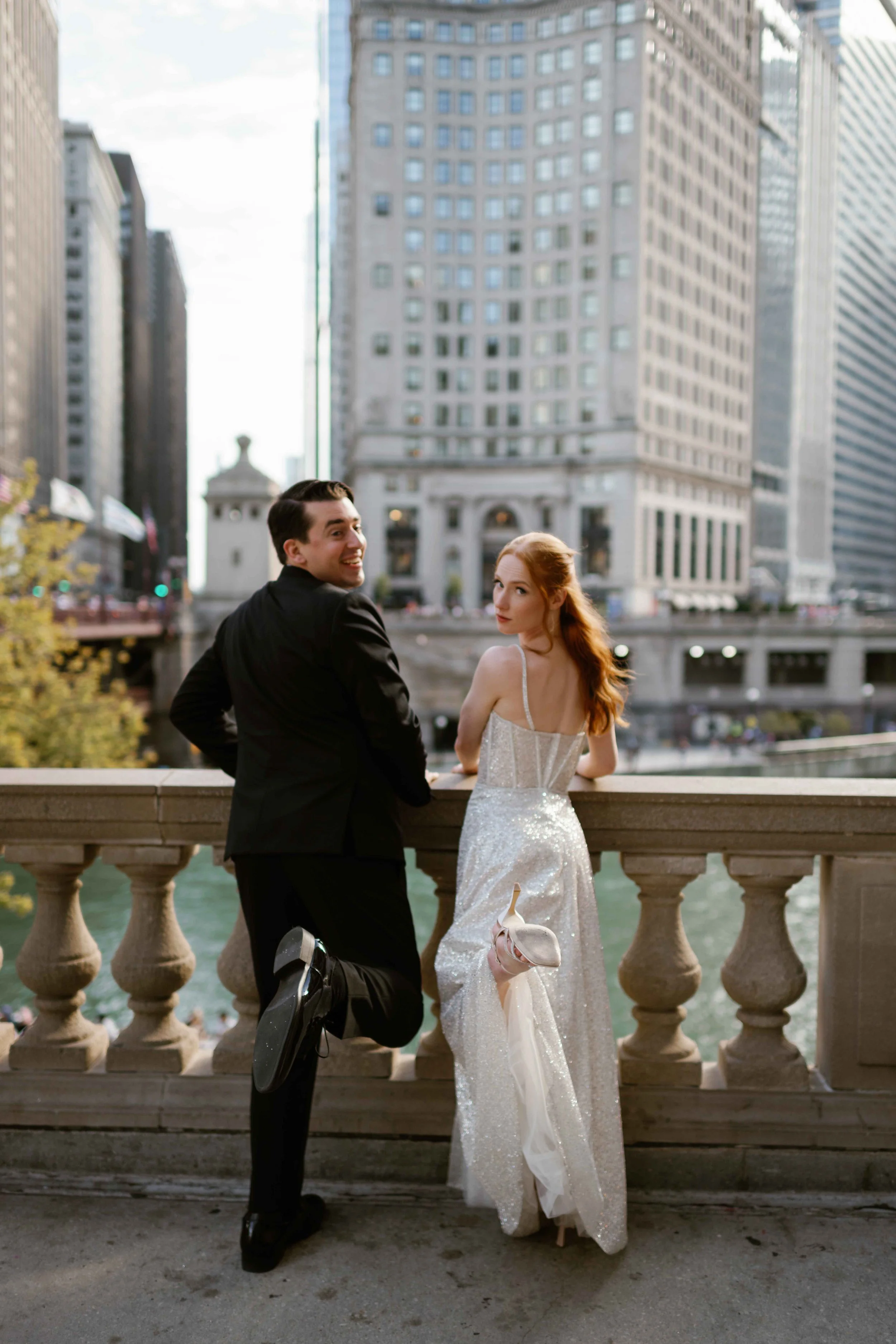 Bride and Groom being silly during wedding photos downtown Chicago by Wrigley building
