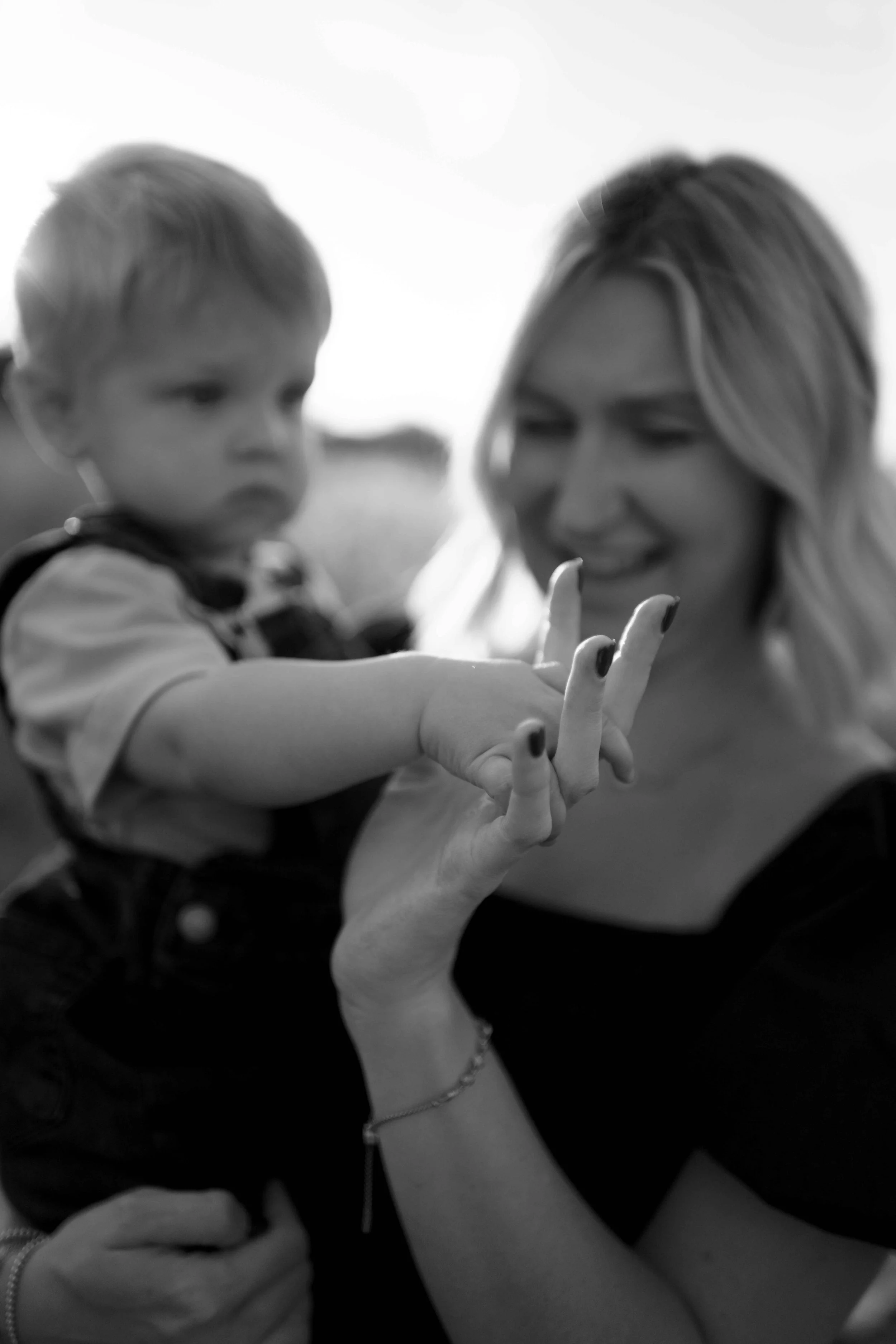 close up black and white photo of mom and son's hands at Blackwell Forest Preserve Wheaton 