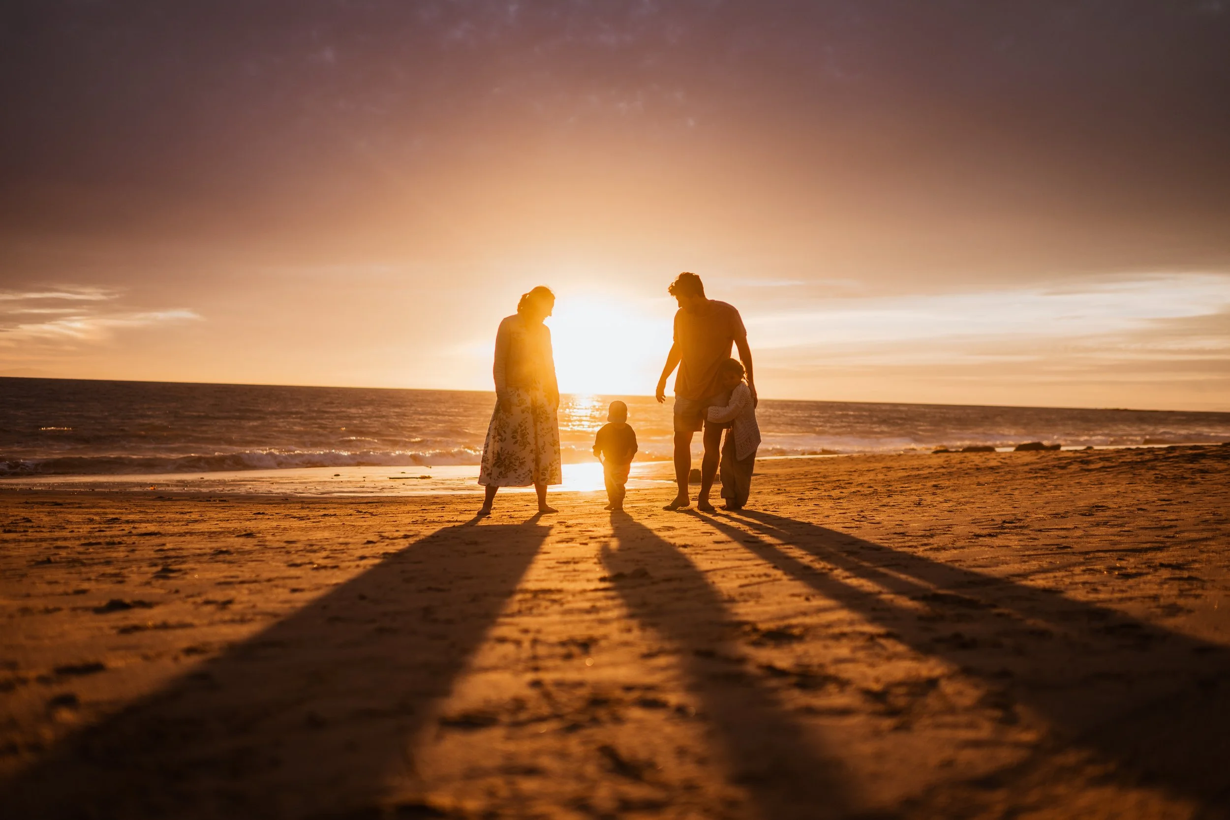 California sunset of family of four on the beach