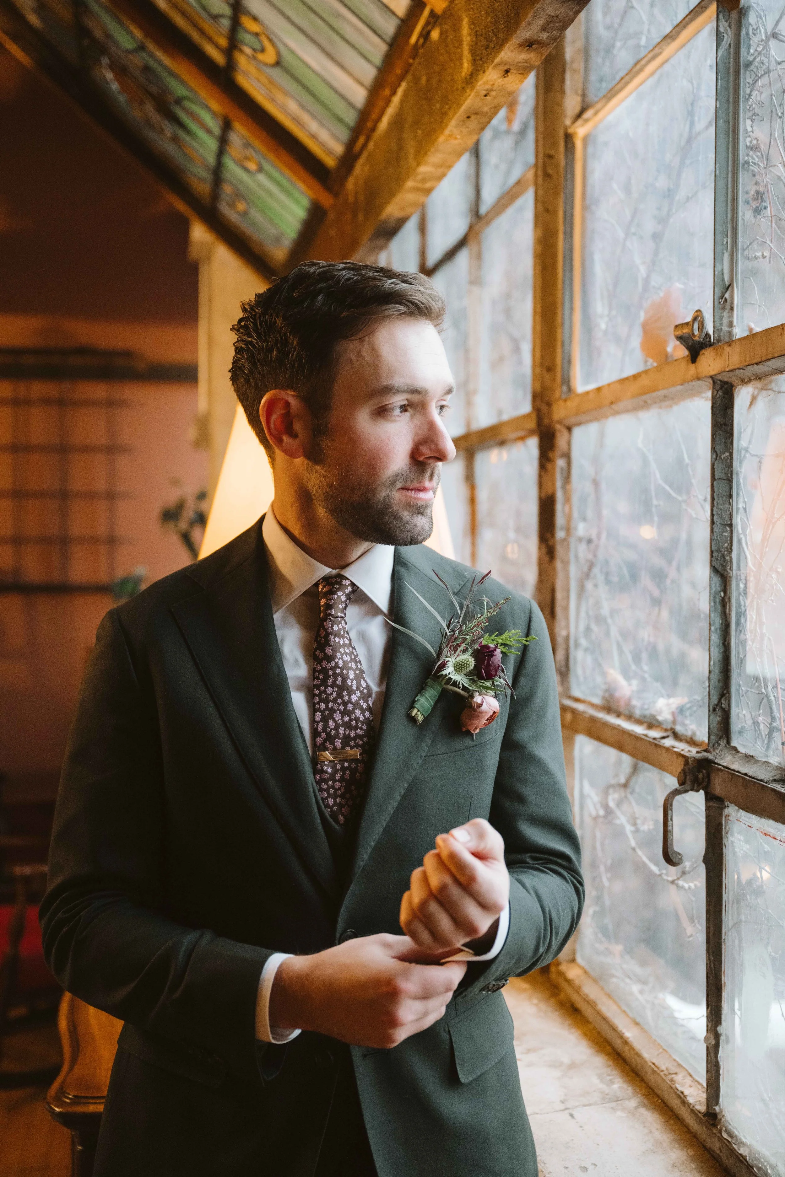 Groom portrait looking out window at Salvage One in Chicago