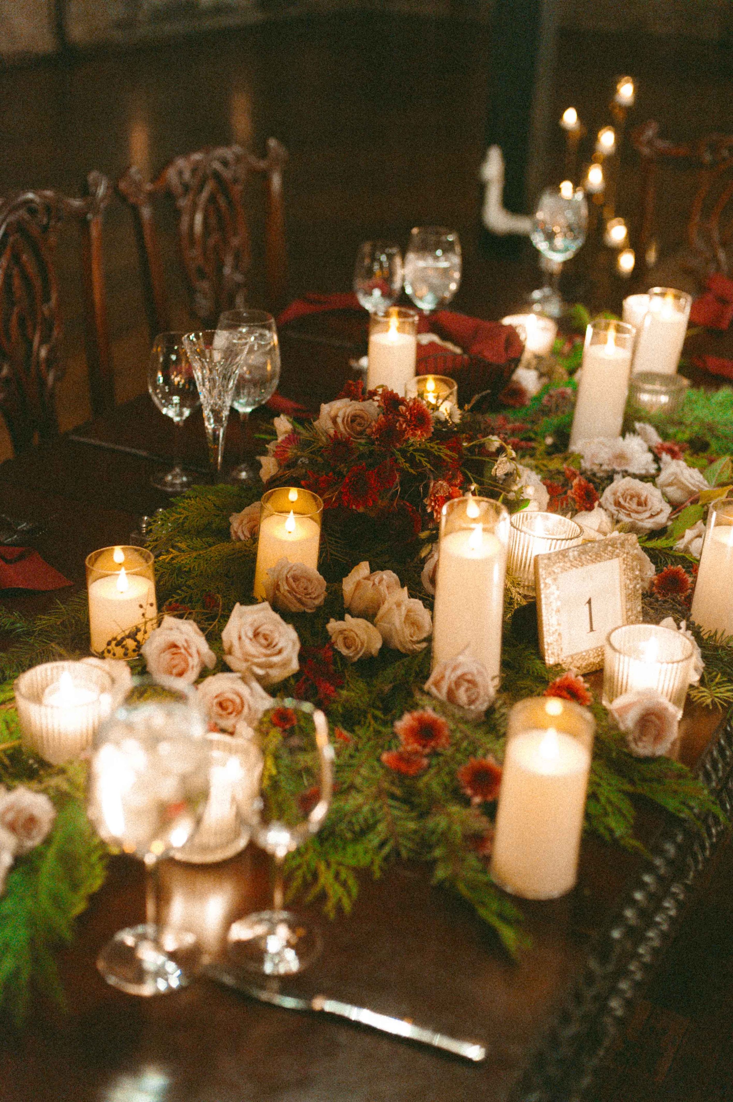salvage one, chicago il wedding reception decor greenery and red roses and candles for winter wedding
