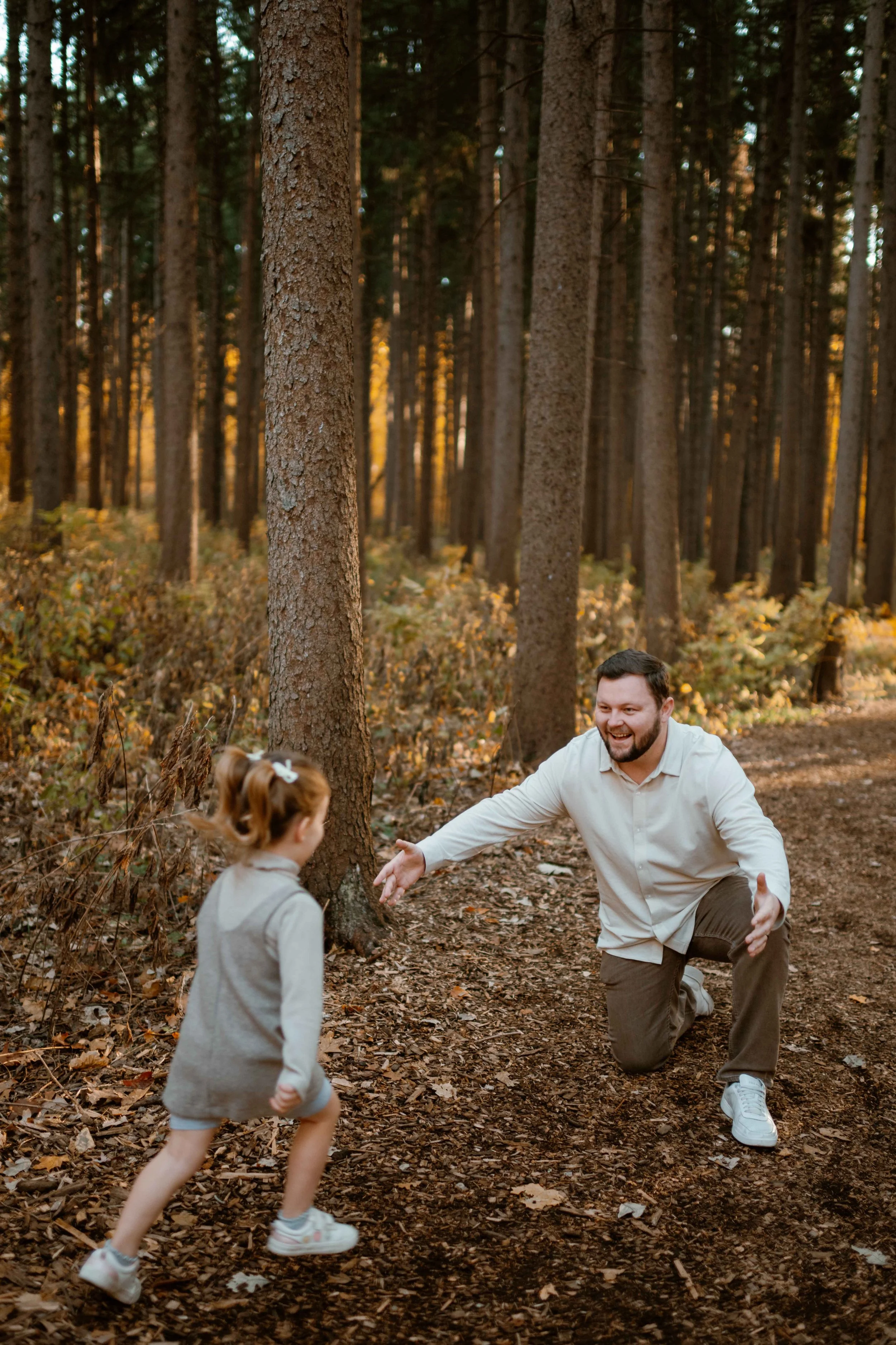 Daughter running into dad's arm at Morton Arboretum Lisle IL 