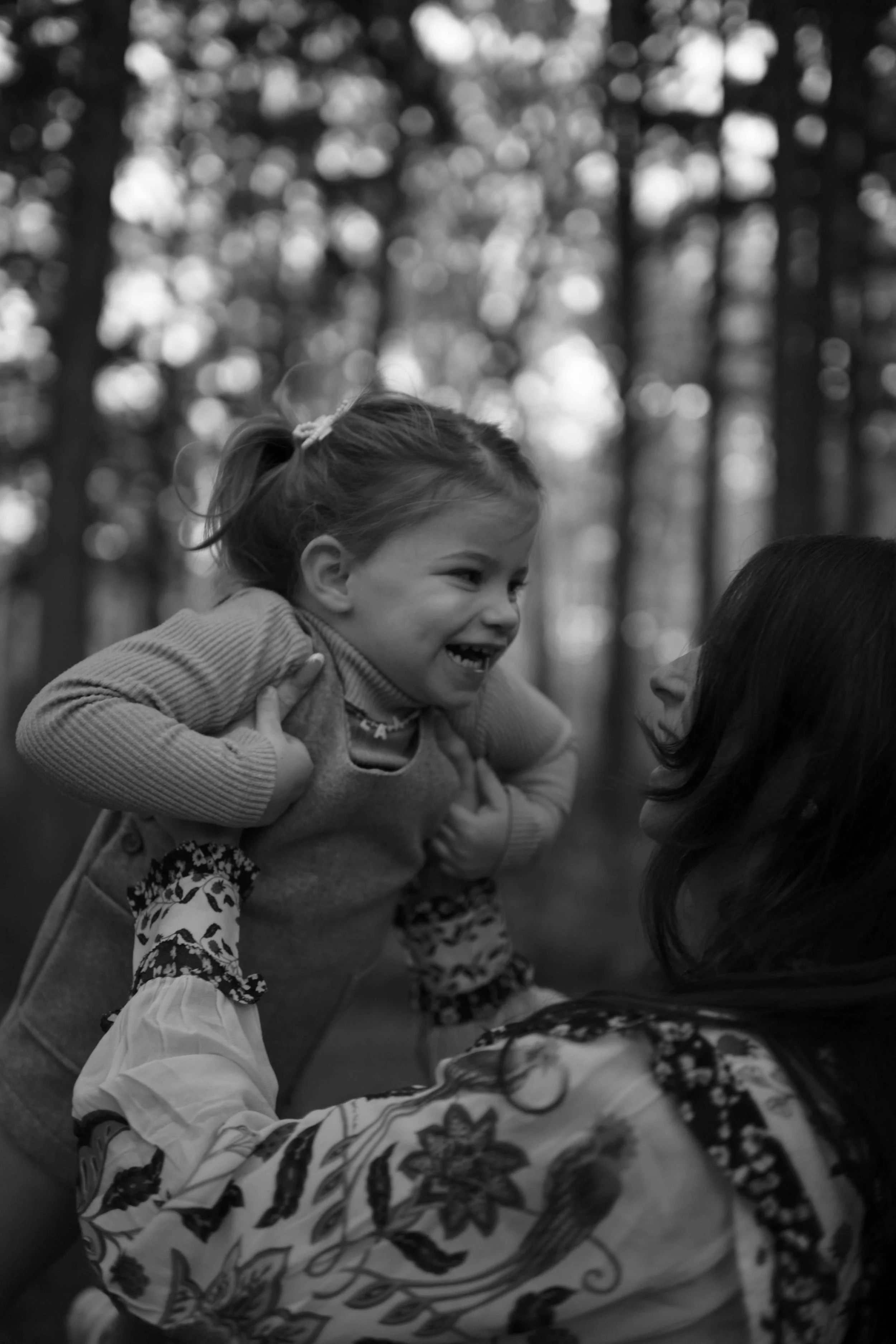 mom lifting daughter in the air at Morton Arboretum Lisle IL 