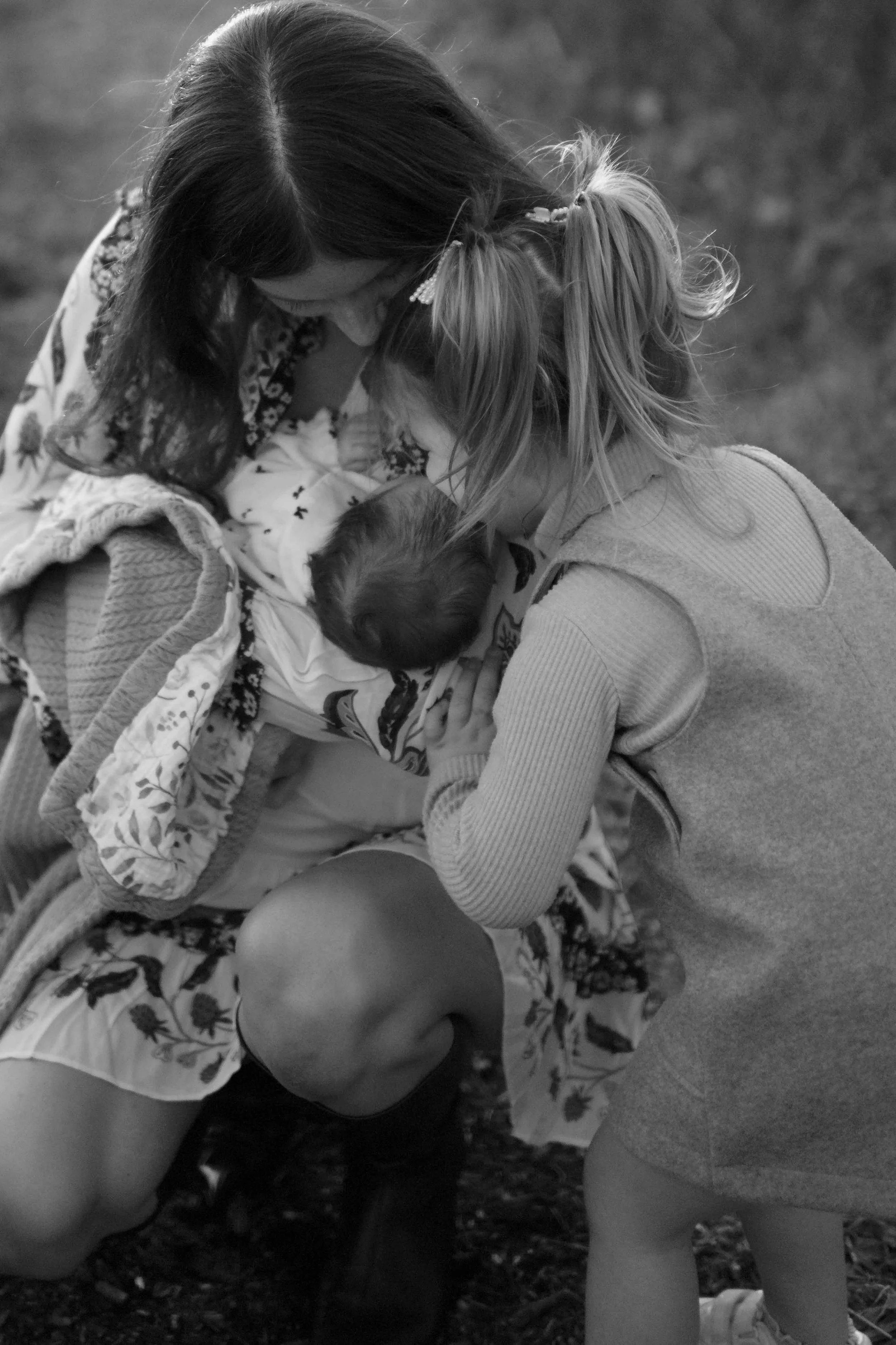black and white closeup photo of toddler girl hugging new baby at Morton Arboretum Lisle IL 