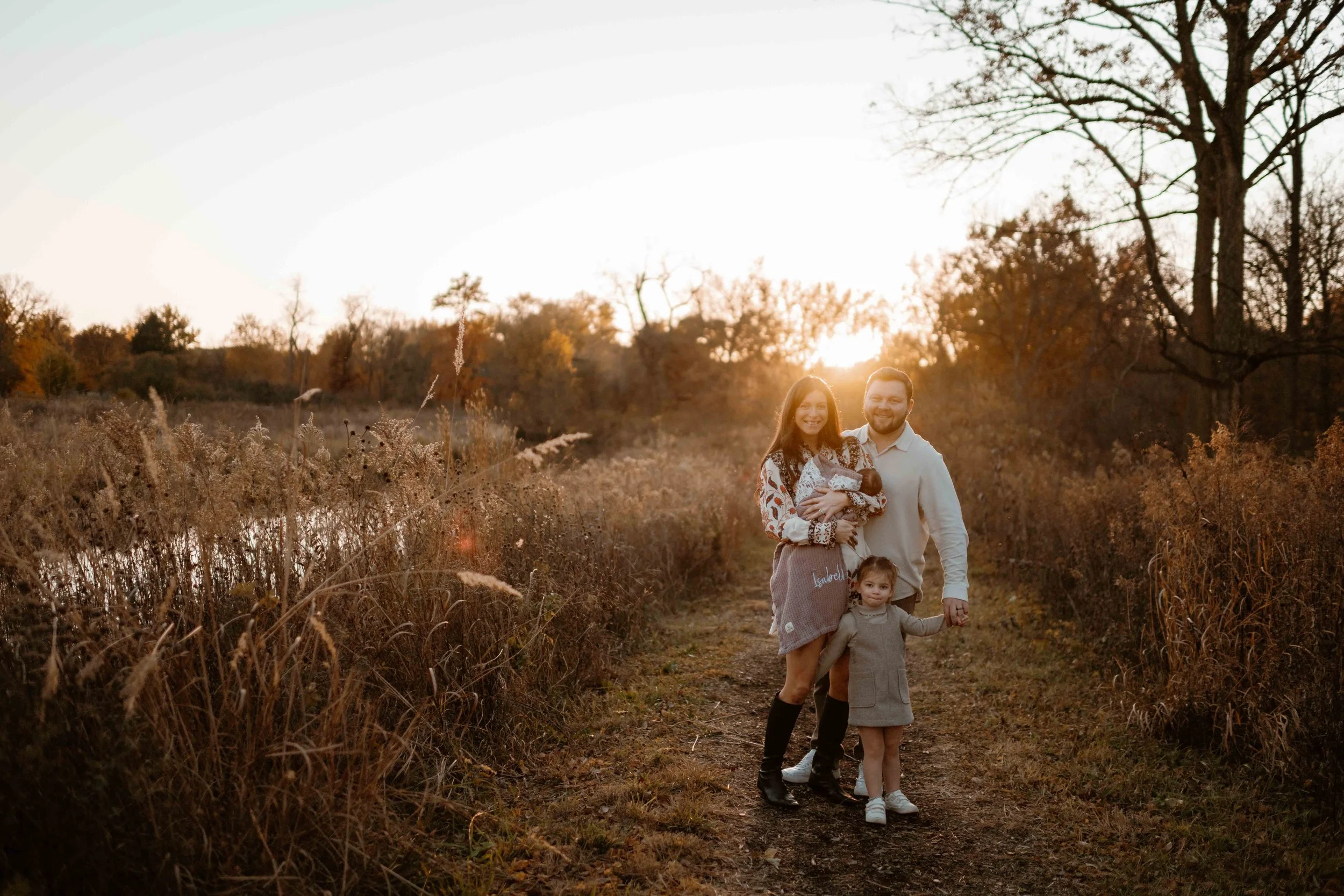 classic family of four smiling at sunset at the Morton Arboretum Lisle IL 
