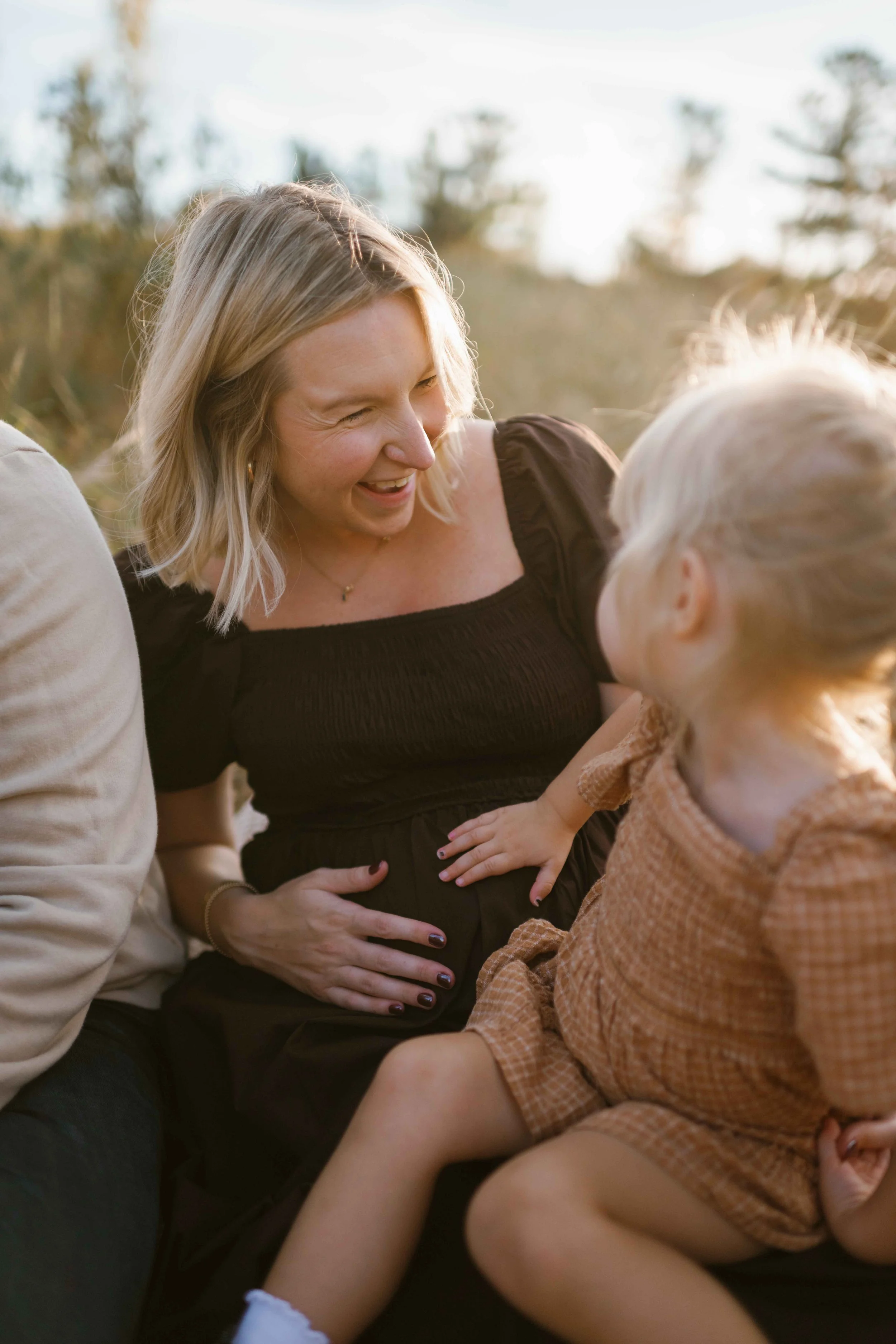 3 year old daughter touching mom's pregnant belly at Blackwell Forest Preserve Wheaton 