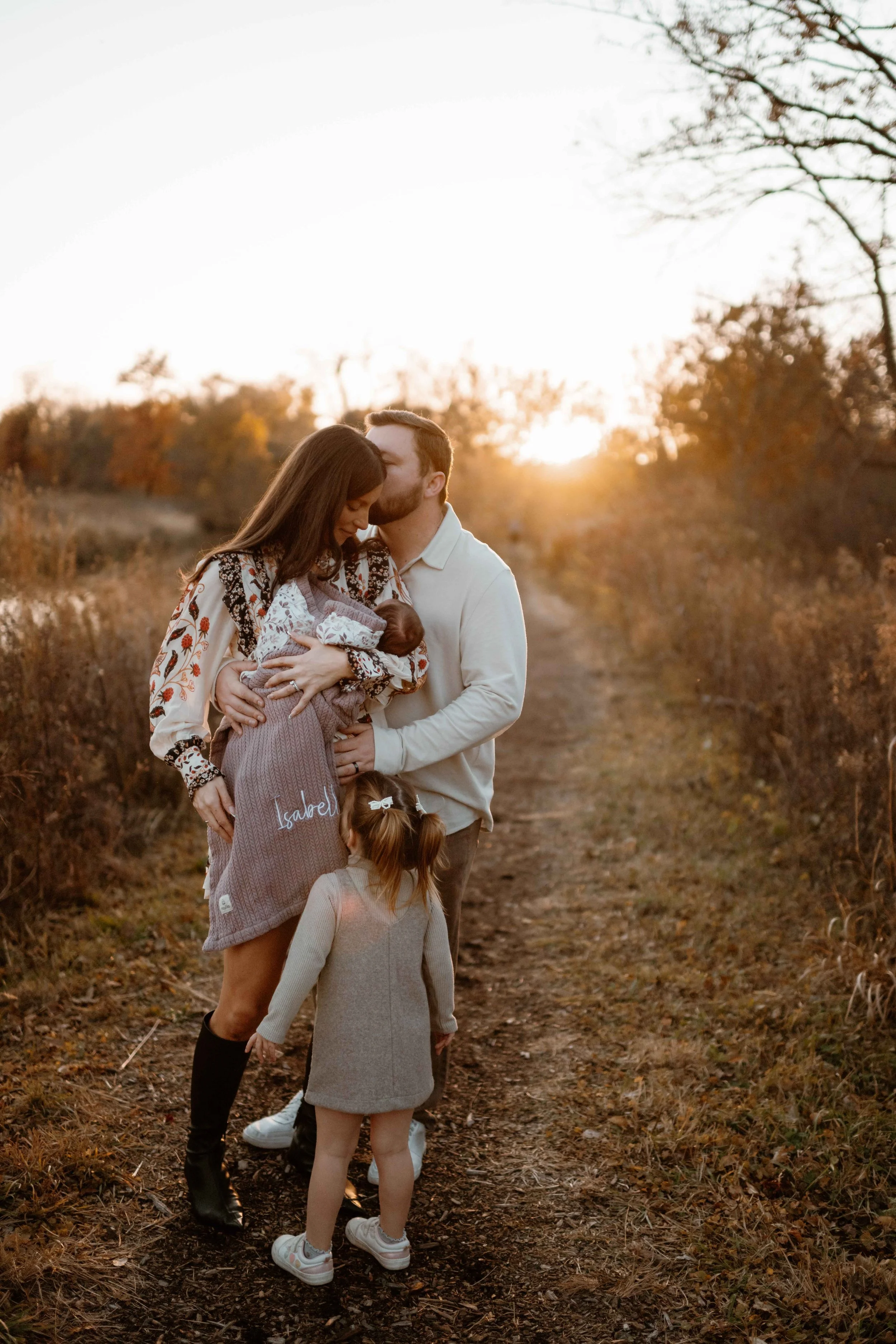 family of four hugging at sunset at the Morton Arboretum Lisle IL 