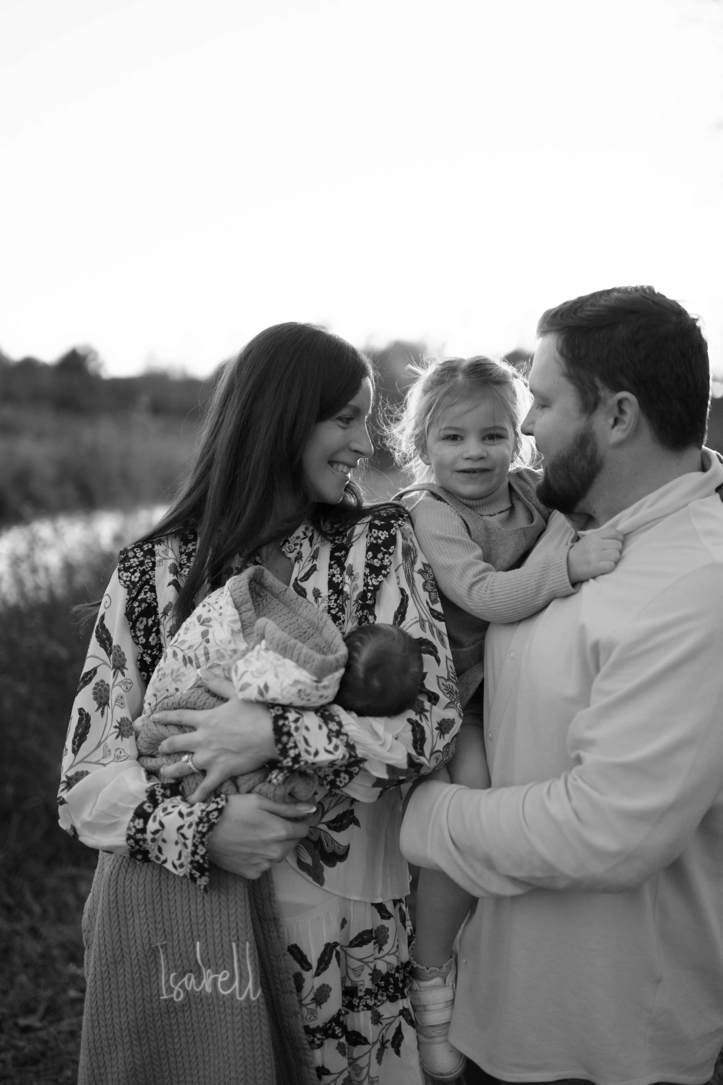 black and white photo dad holding daughter and her smiling at the Morton Arboretum Lisle IL 