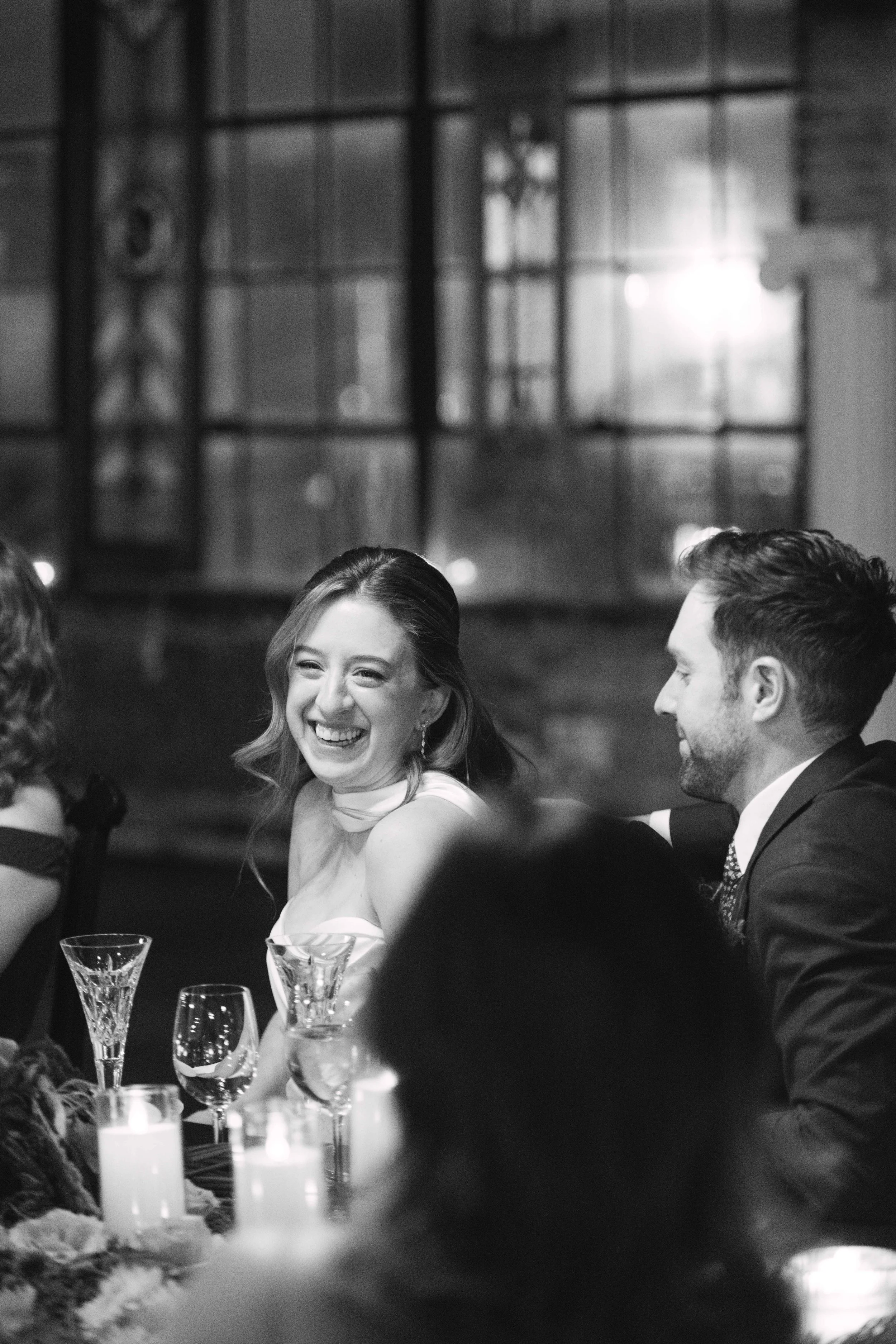 salvage one chicago black and white shot of bride smiling at head table