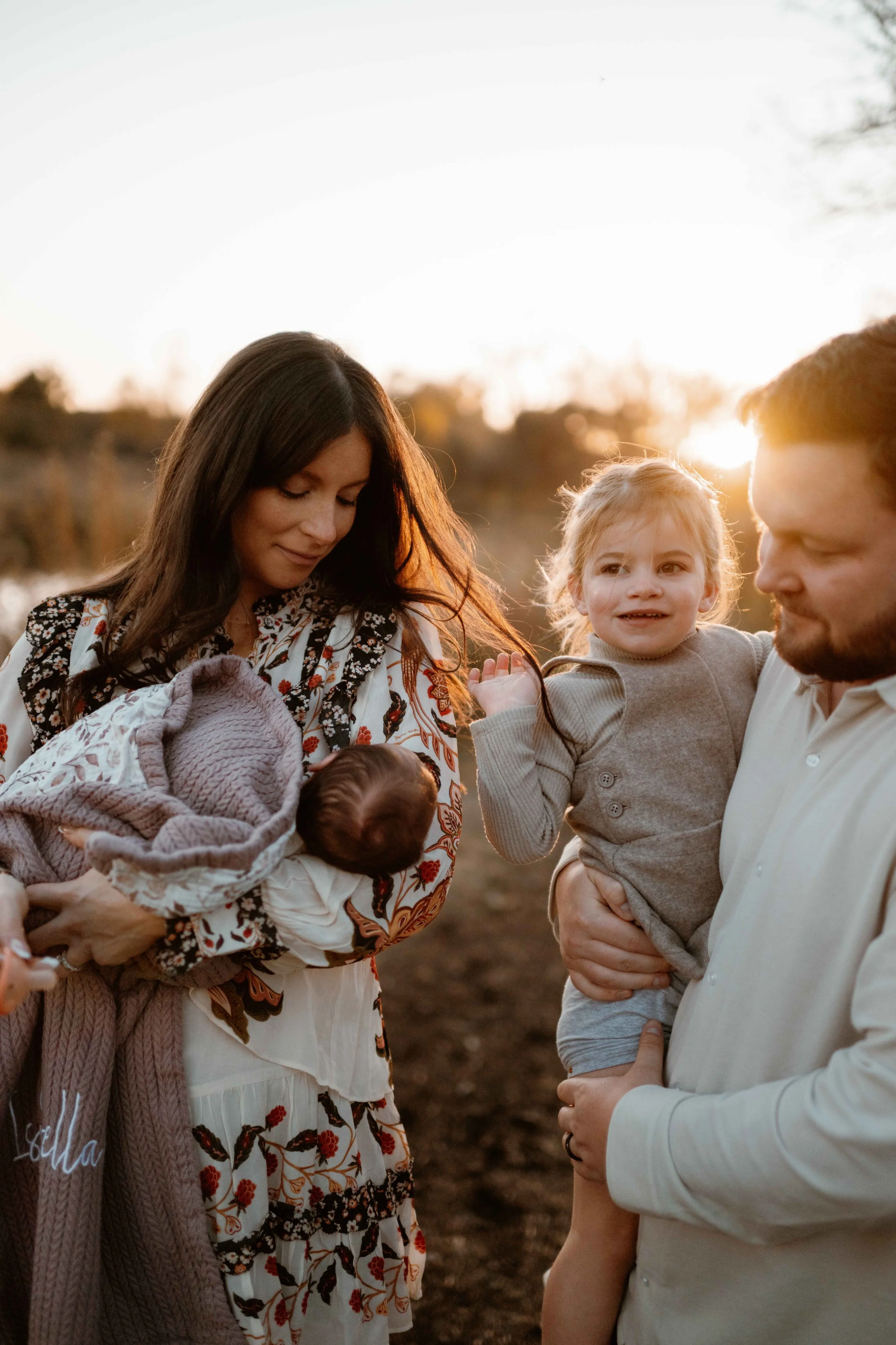 close up of family of four looking at new baby at the Morton Arboretum Lisle IL 