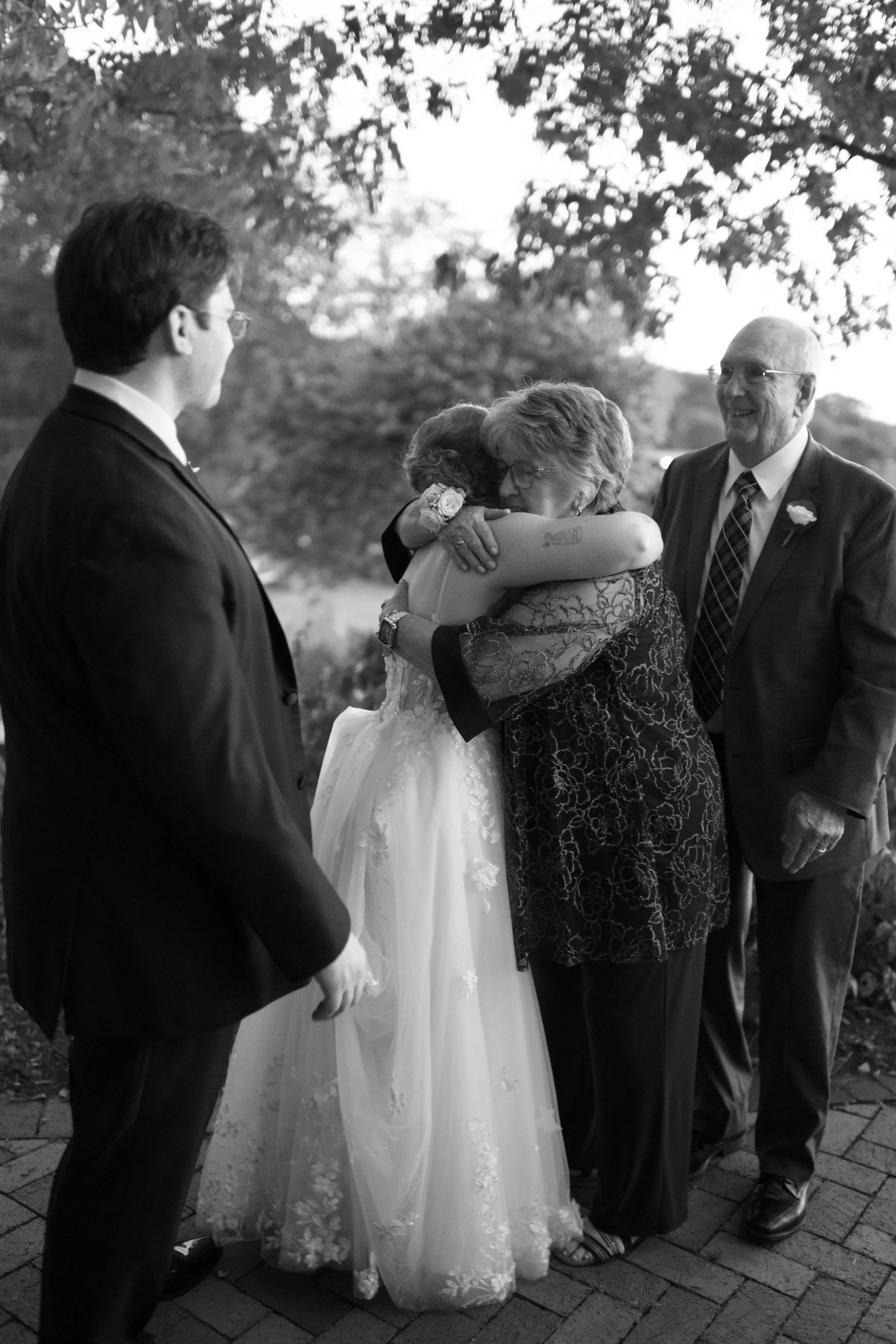 Bride hugging grandmother at wedding