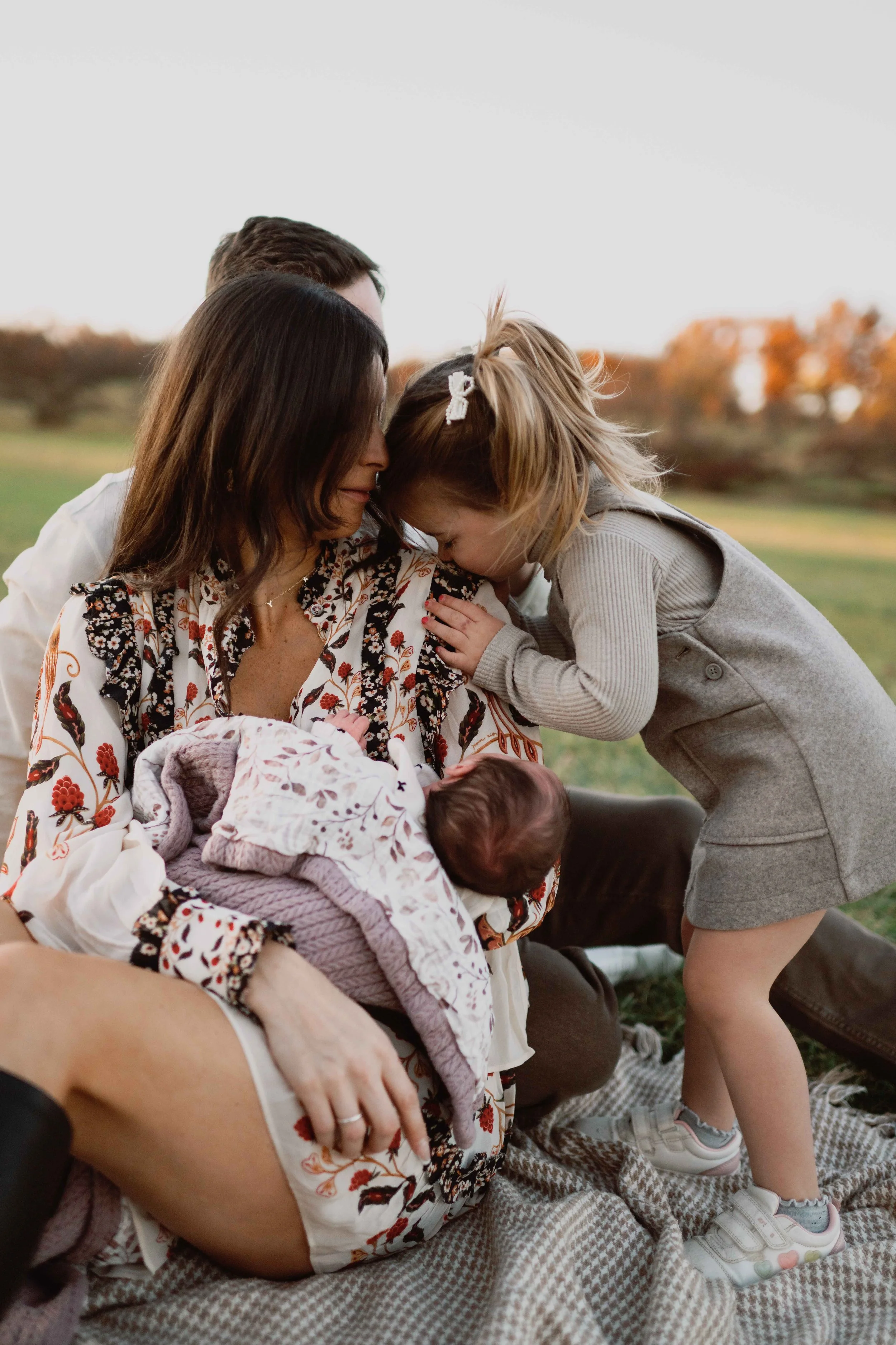 new sister kissing baby's head 