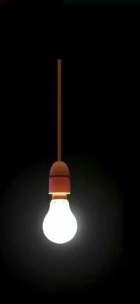 A bright lightbulb hanging from a brown cord against a dark background.