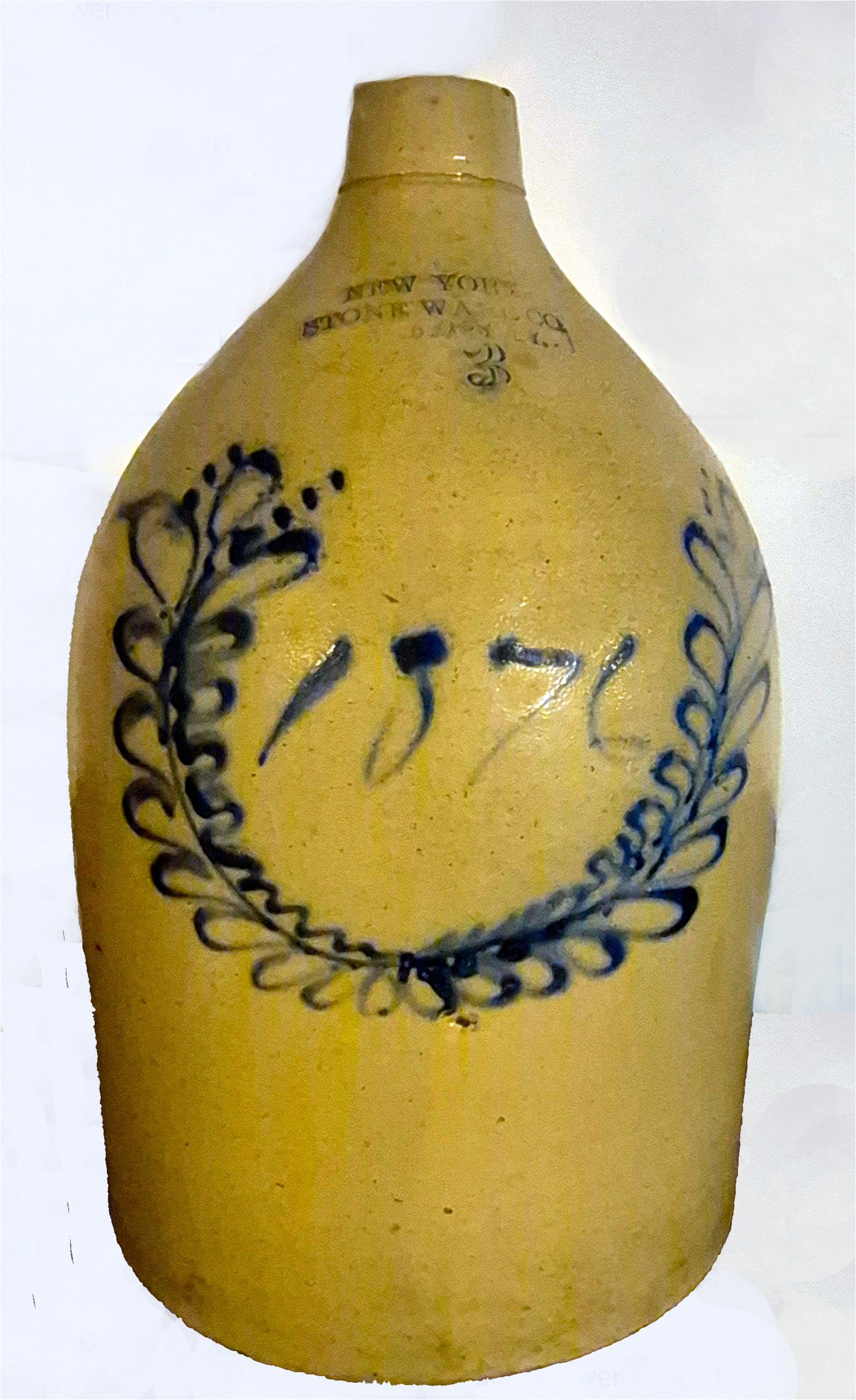  Three-Gallon Centennial Jug, 1876  Extremely rare, three-gallon centennial jug, “1876,” from the New York Stoneware Company, Fort Edward, NY.  The jug is decorated in cobalt tinted slip with the “1876” surrounded by a wreath that signifies victory. 