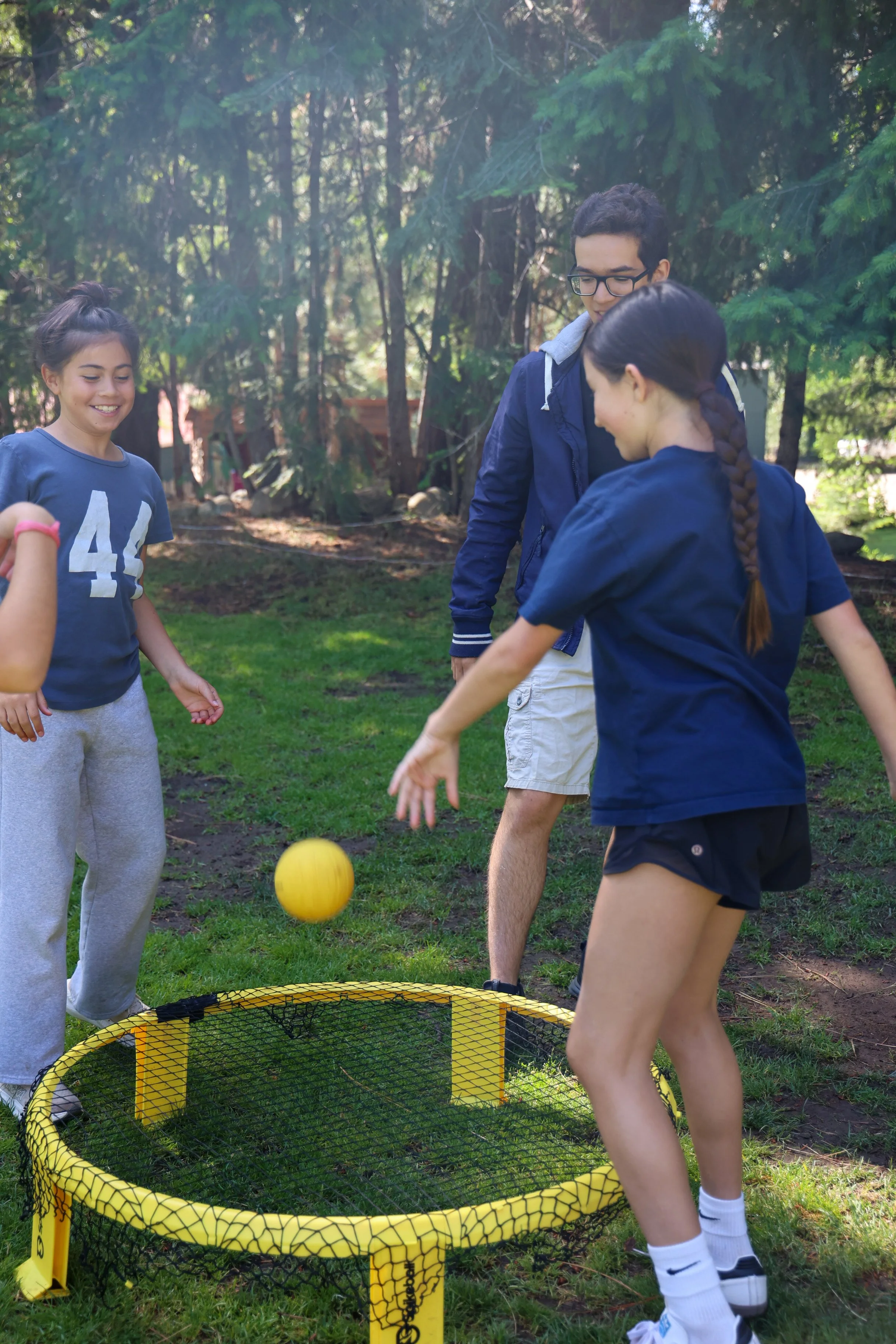 Campers playing group game outdoors during summer camp