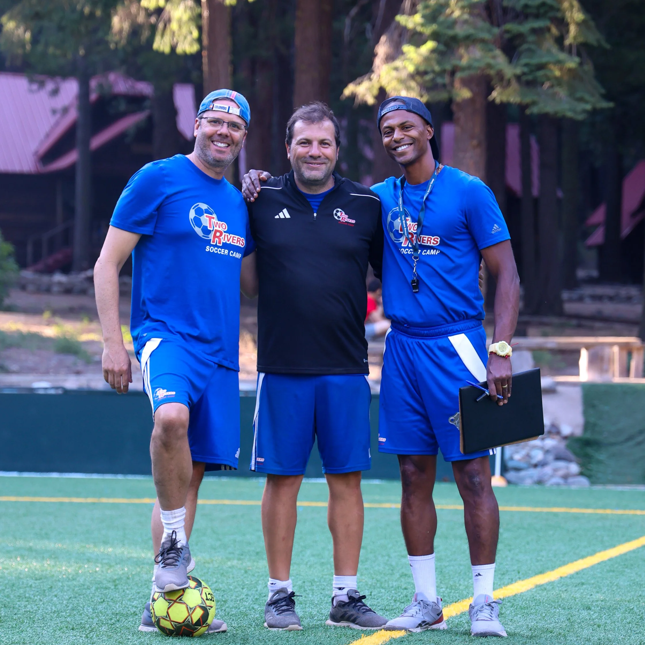 Coaches standing on soccer field during camp