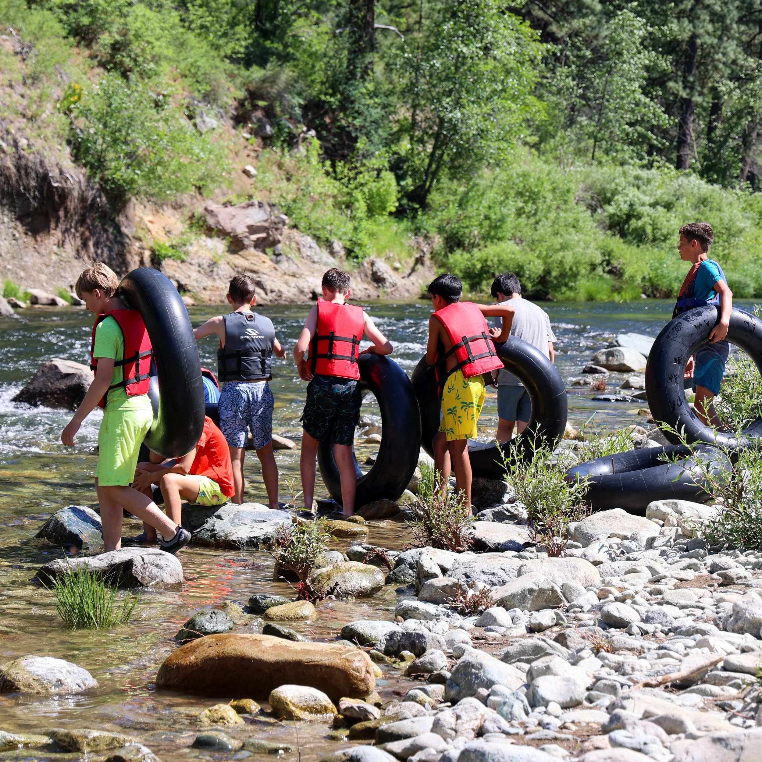 Families gathering outdoors at camp for group event