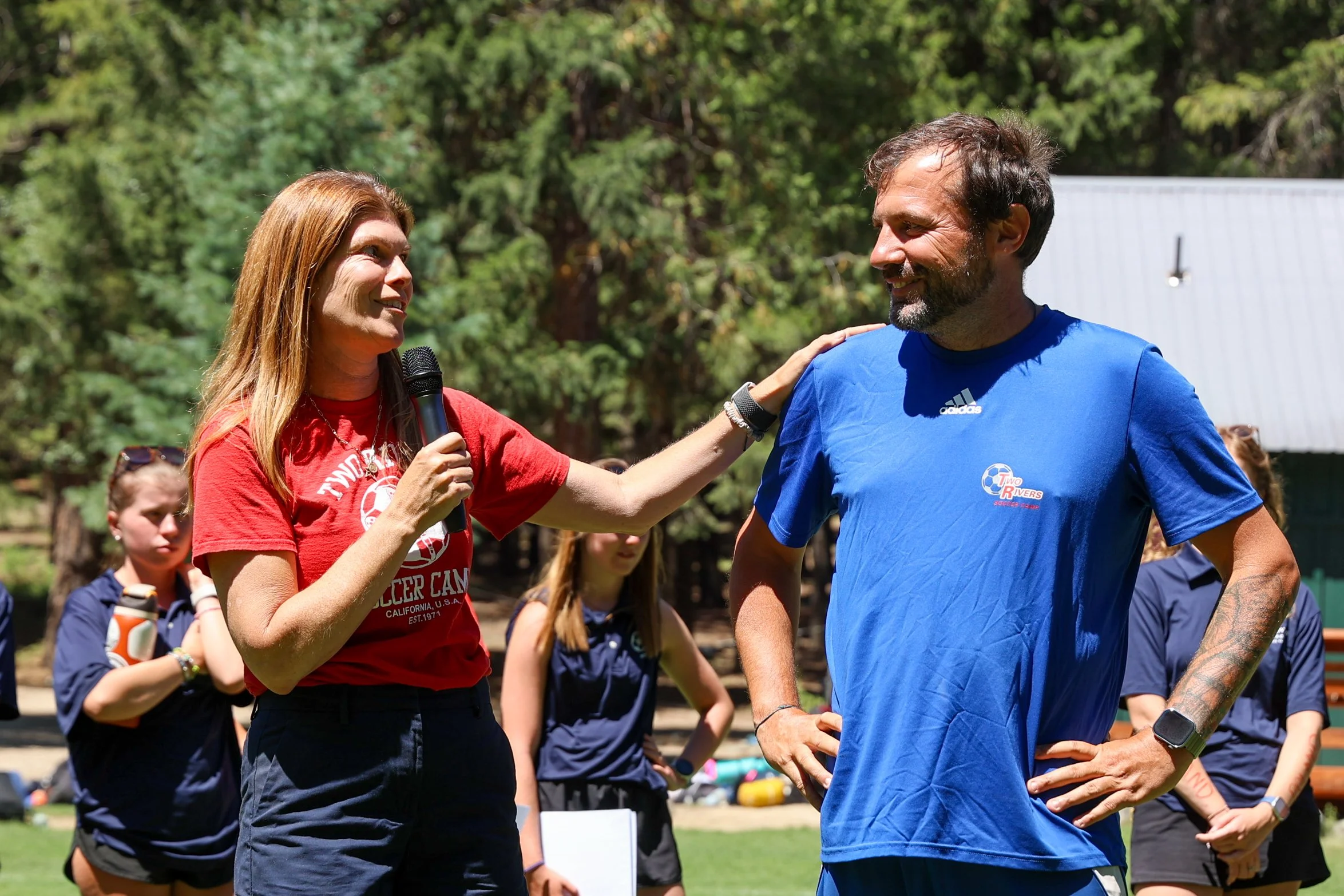 Camp staff connecting and mentoring campers outdoors