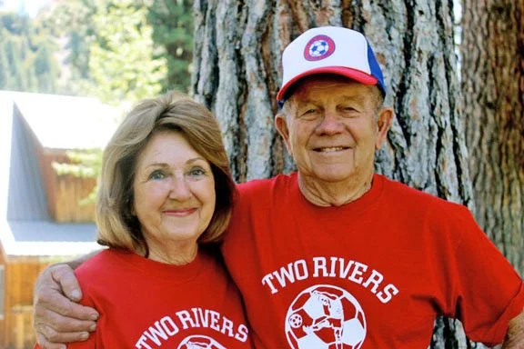 Camp founders and staff smiling together outdoors
