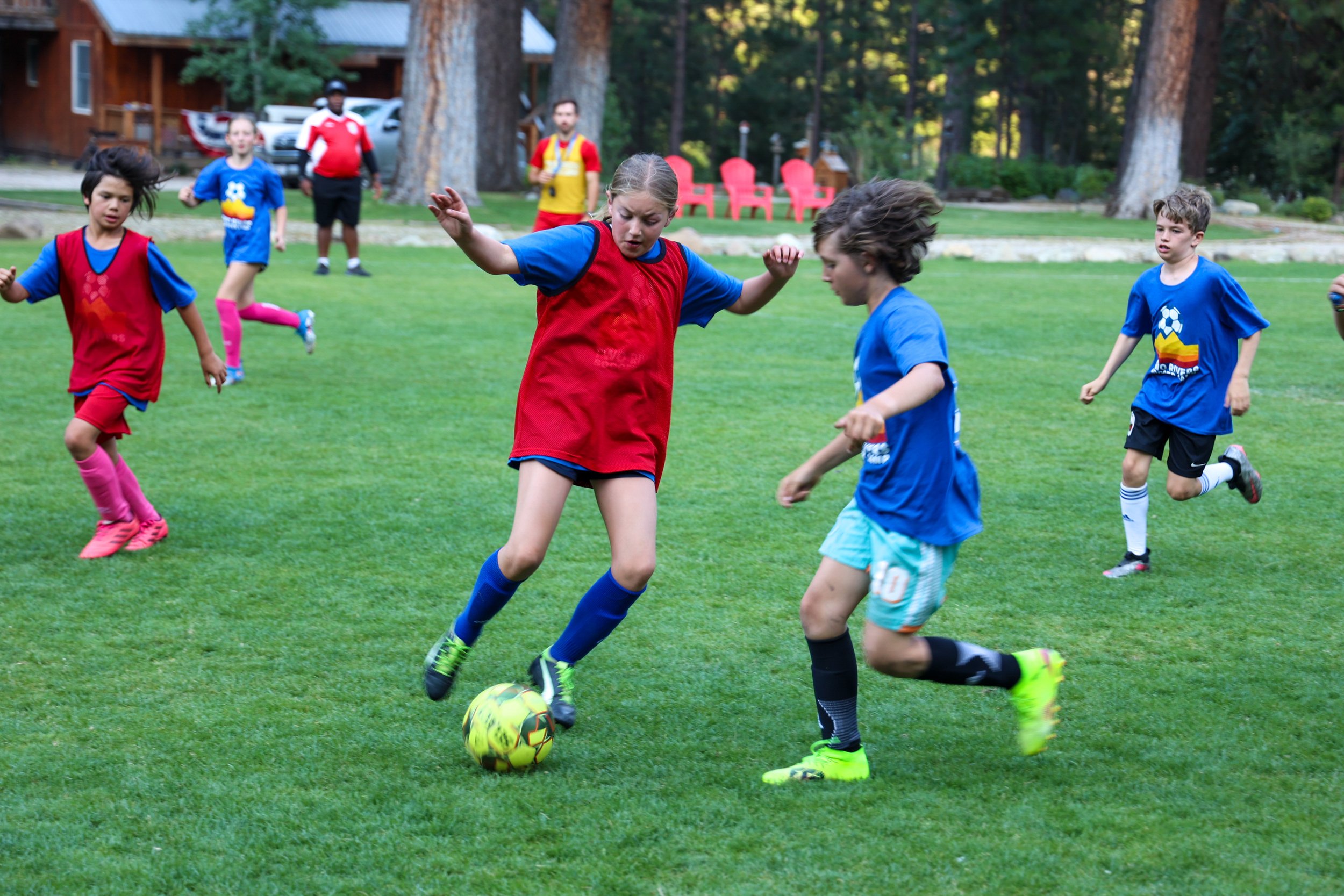 Young soccer players practicing drills during structured training session at overnight camp