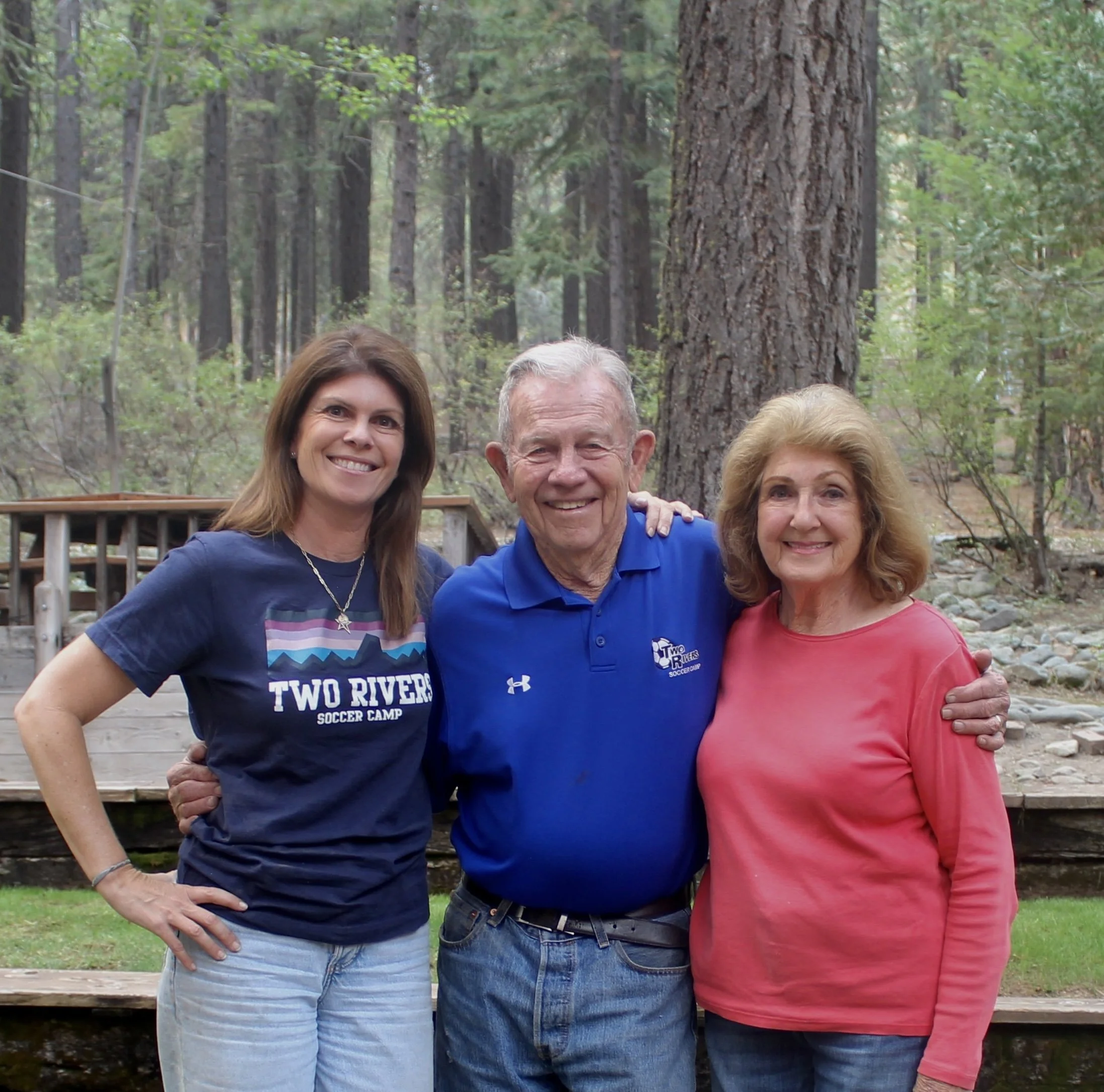 Founders and leadership team of Two Rivers Soccer Camp standing together outdoors