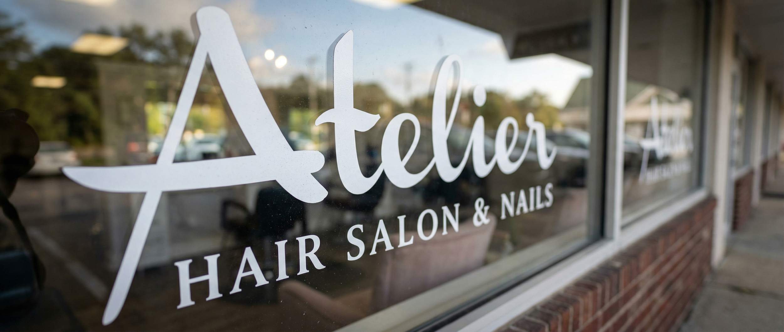 Atelier Hair Salon & Nails storefront window sign in Milford MA - expert hair styling, color, and nail services