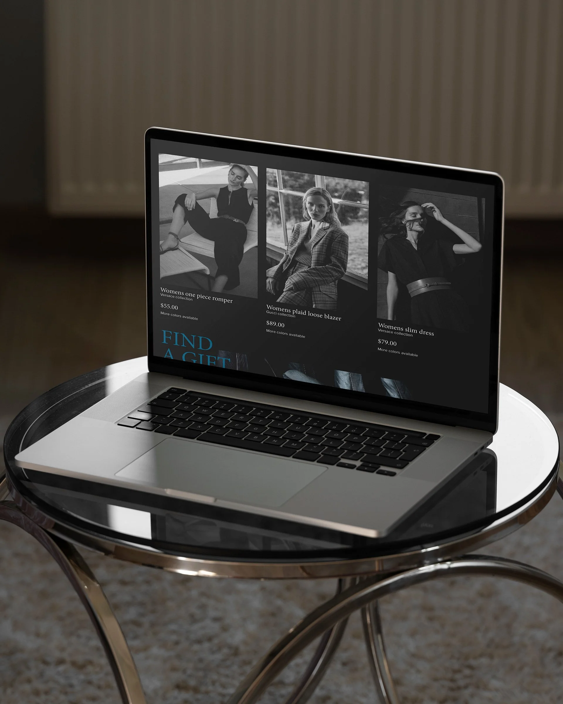 A laptop on a glass table showing an online clothing store with black-and-white images of women modeling different outfits.