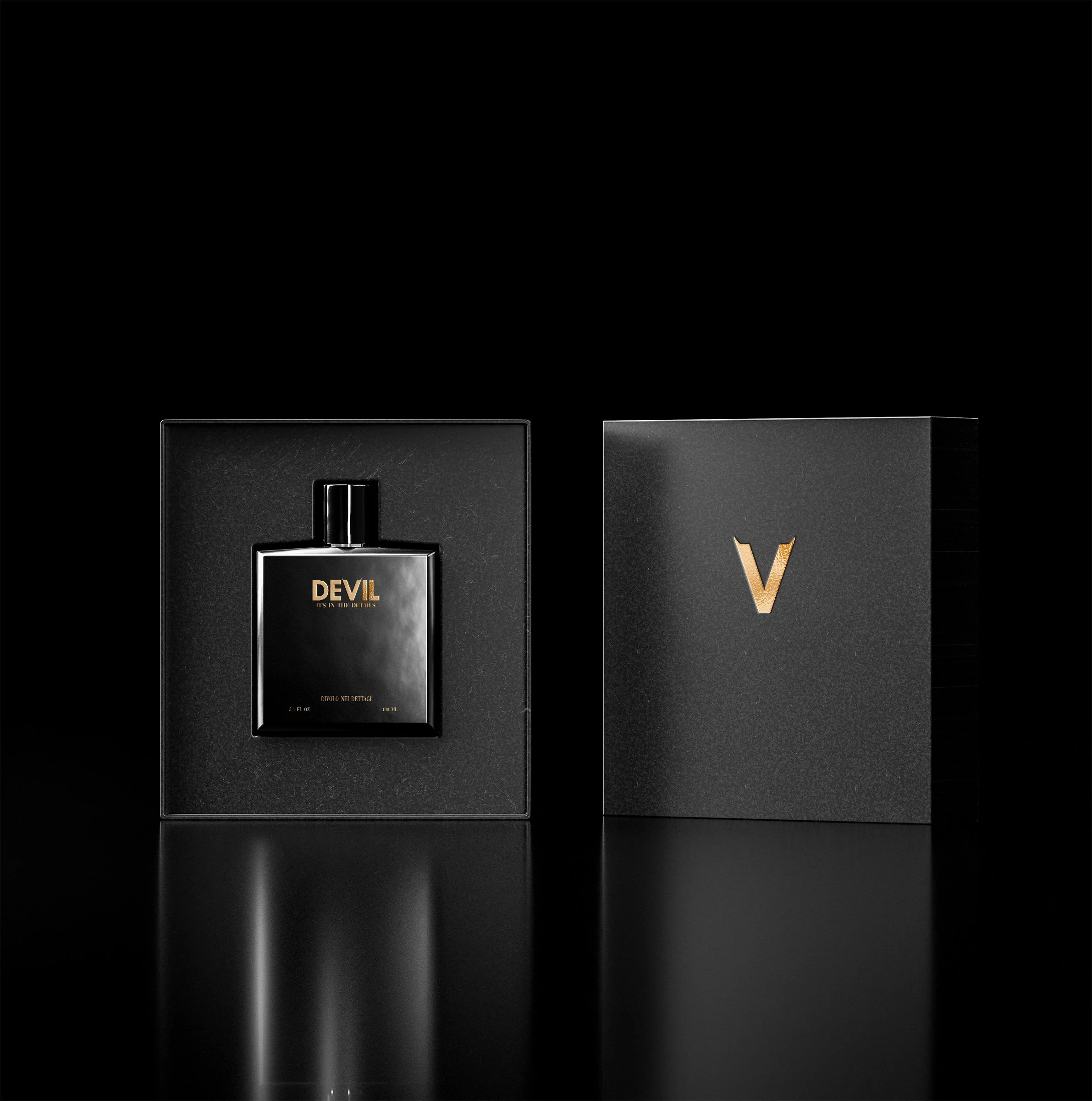 A black perfume bottle labeled 'DEVIL' with gold text, inside a black box with a raised edge, next to another black box with a gold 'V' logo, both set against a black background with reflections on the surface.