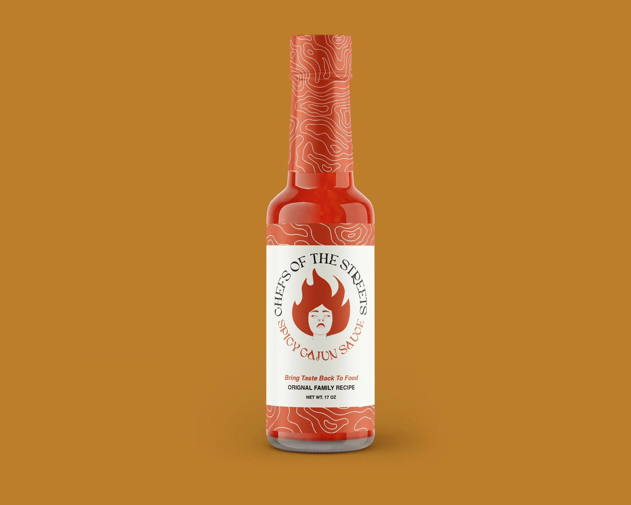 A bottle of Chefs of the Streets Spicy Cajun Sauce with a white label, red cap, and red contents, set against a brown background.