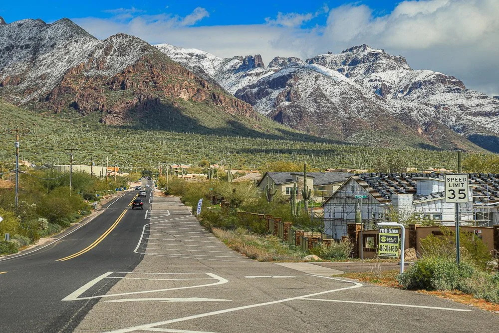 Homes below the snow-covered southern face of the Superstition Mountains.