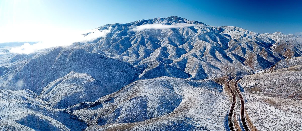 The rugged north slope of Mount Ord, rising to 7,128 feet (2,173 meters), is dusted in snow the morning after a chilly winter storm visited the desert. 