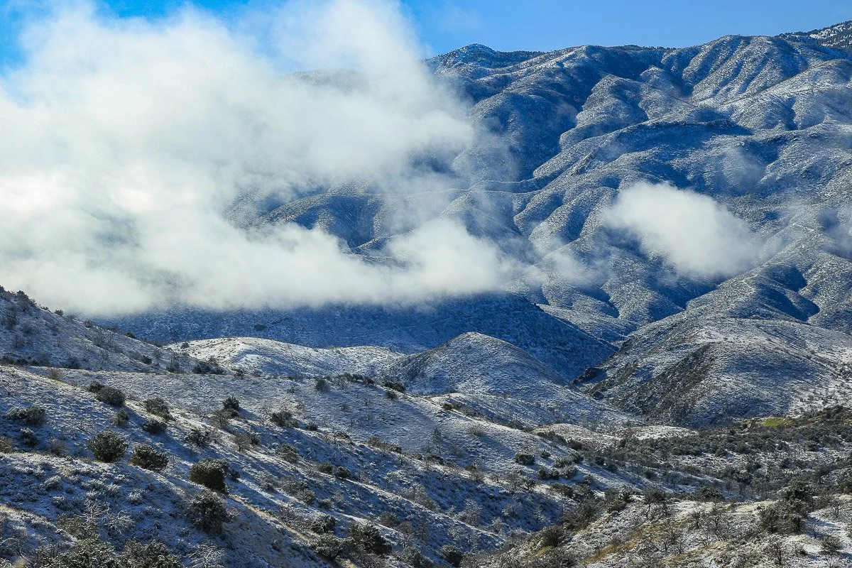 Low winter clouds and snow on the rugged north slope of Mount Ord.