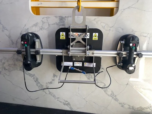 A tile removal tool attached to a wall with a marble-like surface.