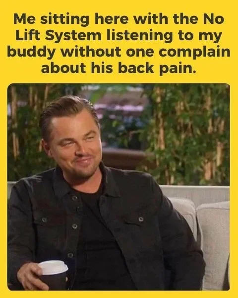 Man sitting on outdoor couch holding a coffee cup with a smirk, with a yellow text overlay saying 'Me sitting here with the No Lift System listening to my buddy without one complain about his back pain.'