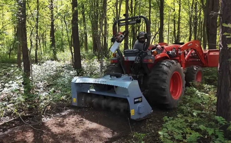 A tractor forest mulching and clearing invasive plant species to make a woodland trail in the Hudson Valley.