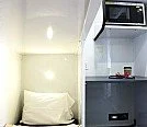 A small sleeping area with a pillow and blanket, part of a compact living space in a bunkhouse rental trailer.