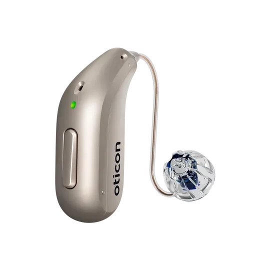 Hearing aid with a beige body and a clear ear tip connected by a thin wire.