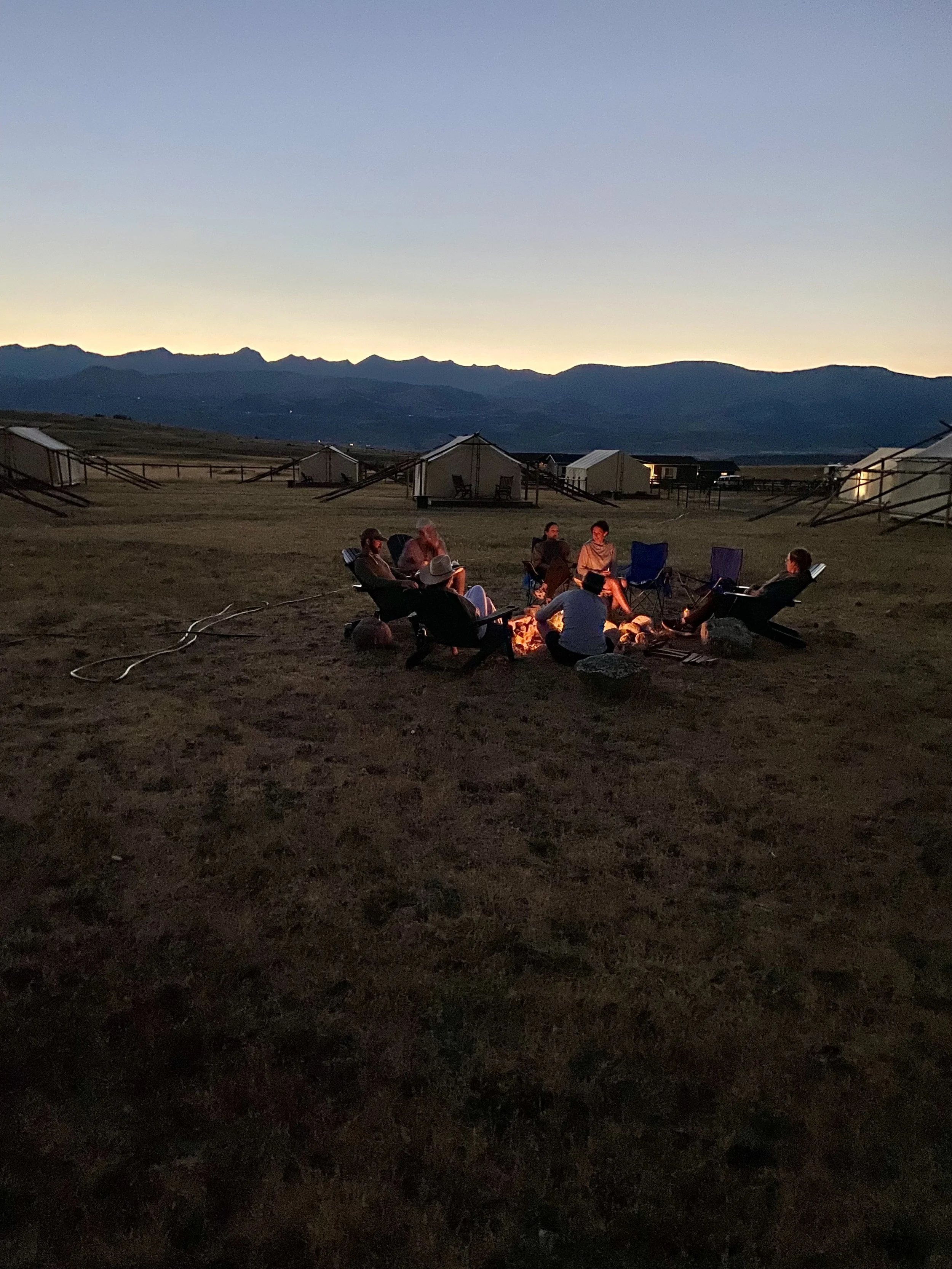 People sitting around a campfire at night