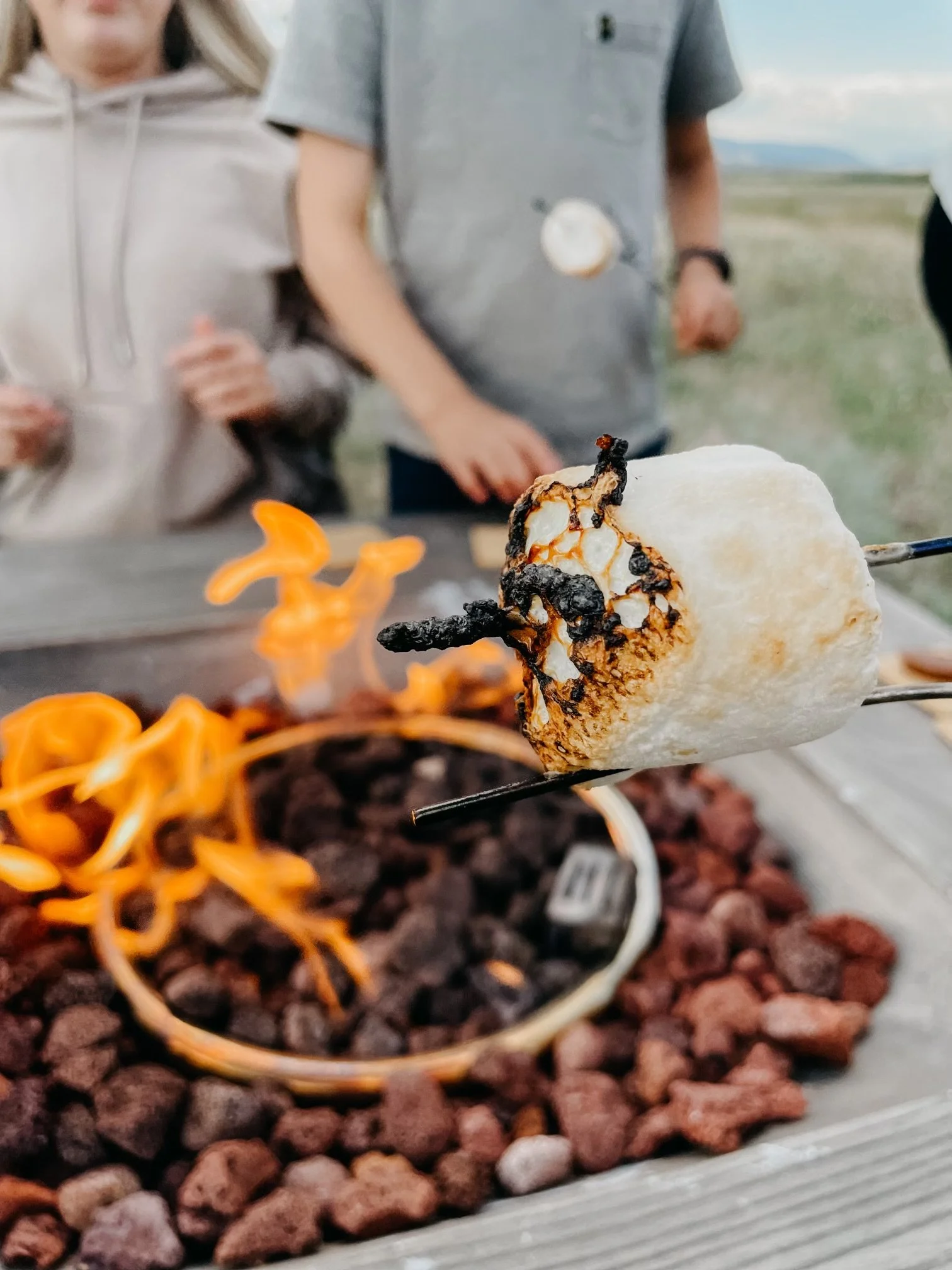 Marshmallow roasting over a campfire flame