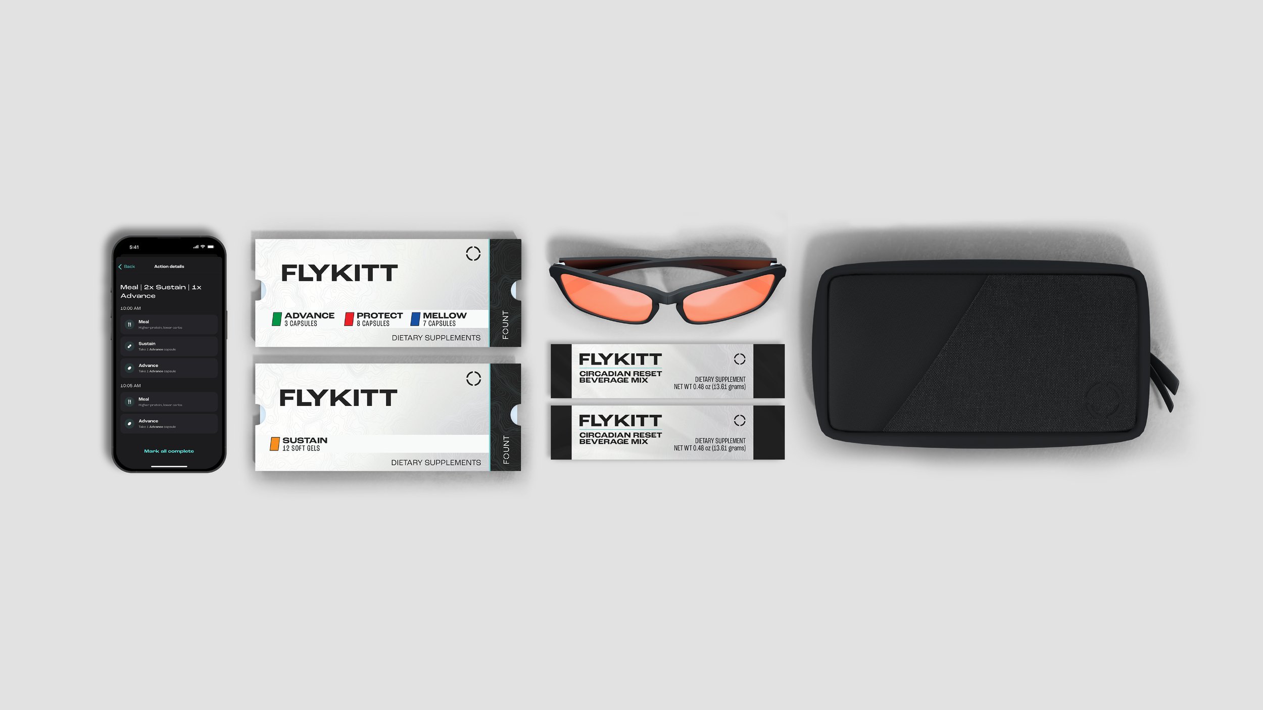 A flat lay of health technology and accessories including a smartphone displaying a medication tracking app, two boxes of dietary supplements labeled 'FLYKITT' with different formulas, a pair of tinted sunglasses, and a black carrying case on a light gray surface.