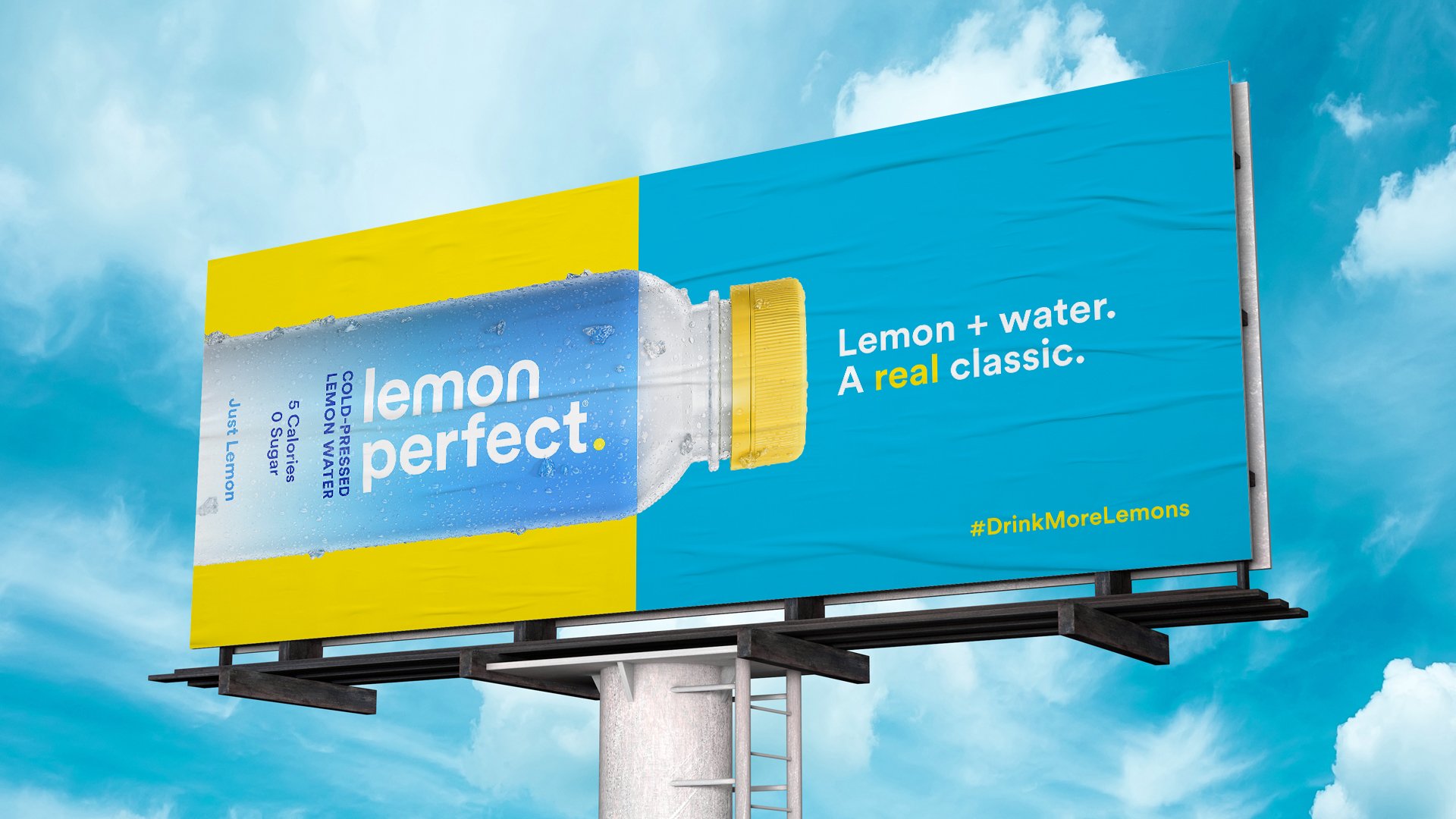 Billboard advertisement for Lemon Perfect flavored water with lemon and water, showing a bottle with a yellow cap and a blue label, against a background of cloudy sky.