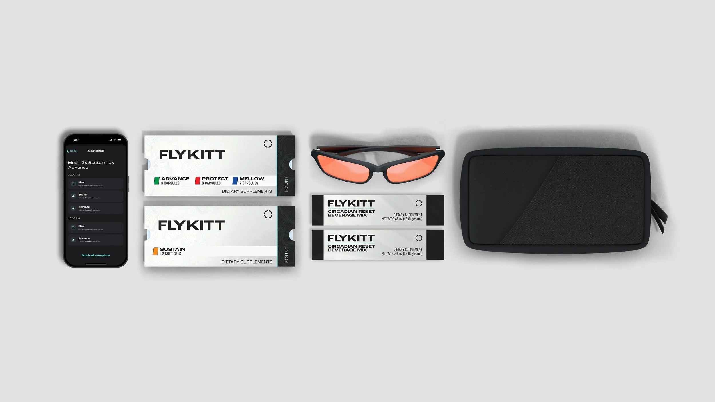 A collection of health and wellness products, including a smartphone with a meal tracking app, FLYKITT dietary supplement boxes, orange-tinted sunglasses, and a black carrying case, all arranged on a light gray surface.