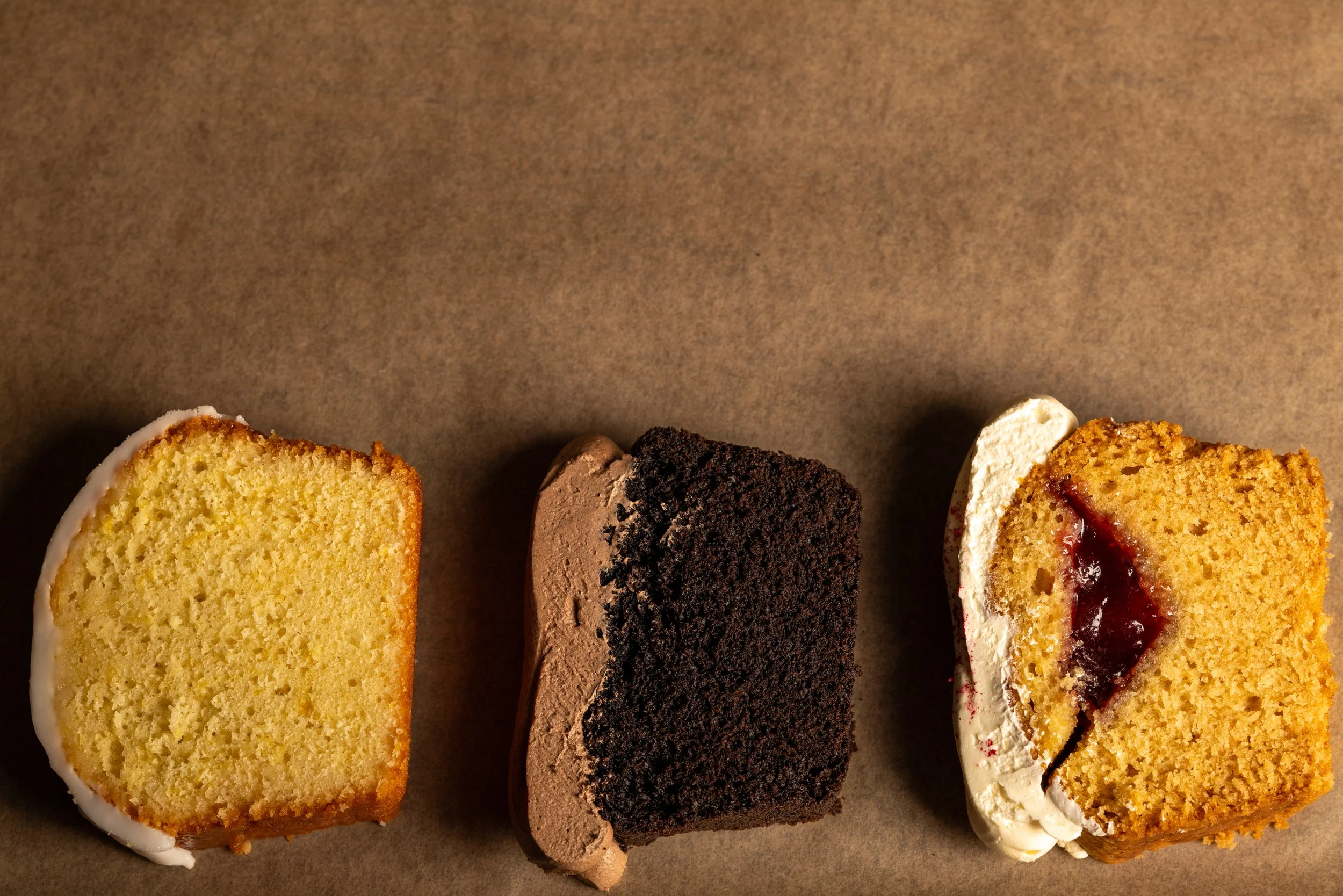Our loaf cakes - Lemon drizzle with lemon glaze icing, Plant based Victoria sponge with raspberry jam, Plant based chocolate loaf with chocolate frosting
