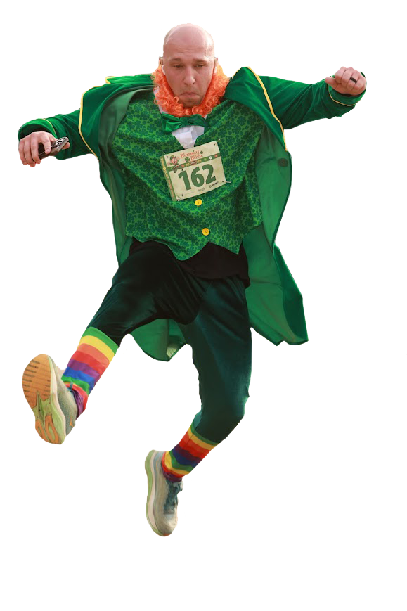 A man in colorful attire, wearing a green jacket, a green vest with a race bib number 162, rainbow socks, and sneakers, appears to be jumping or posing dynamically.