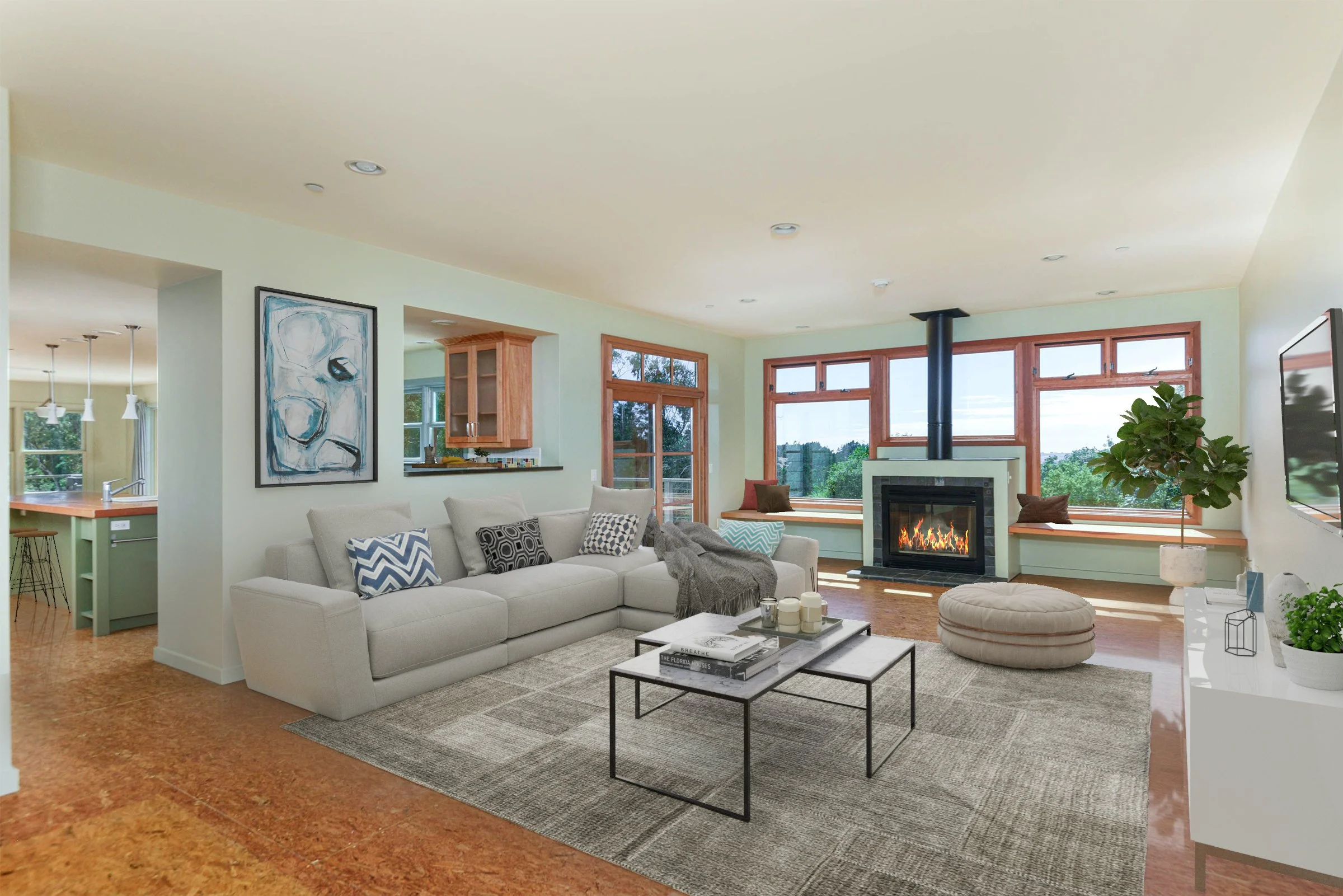 Living room with large window, fireplace, white sofa with patterned pillows, and a coffee table, in a well-lit, modern home.