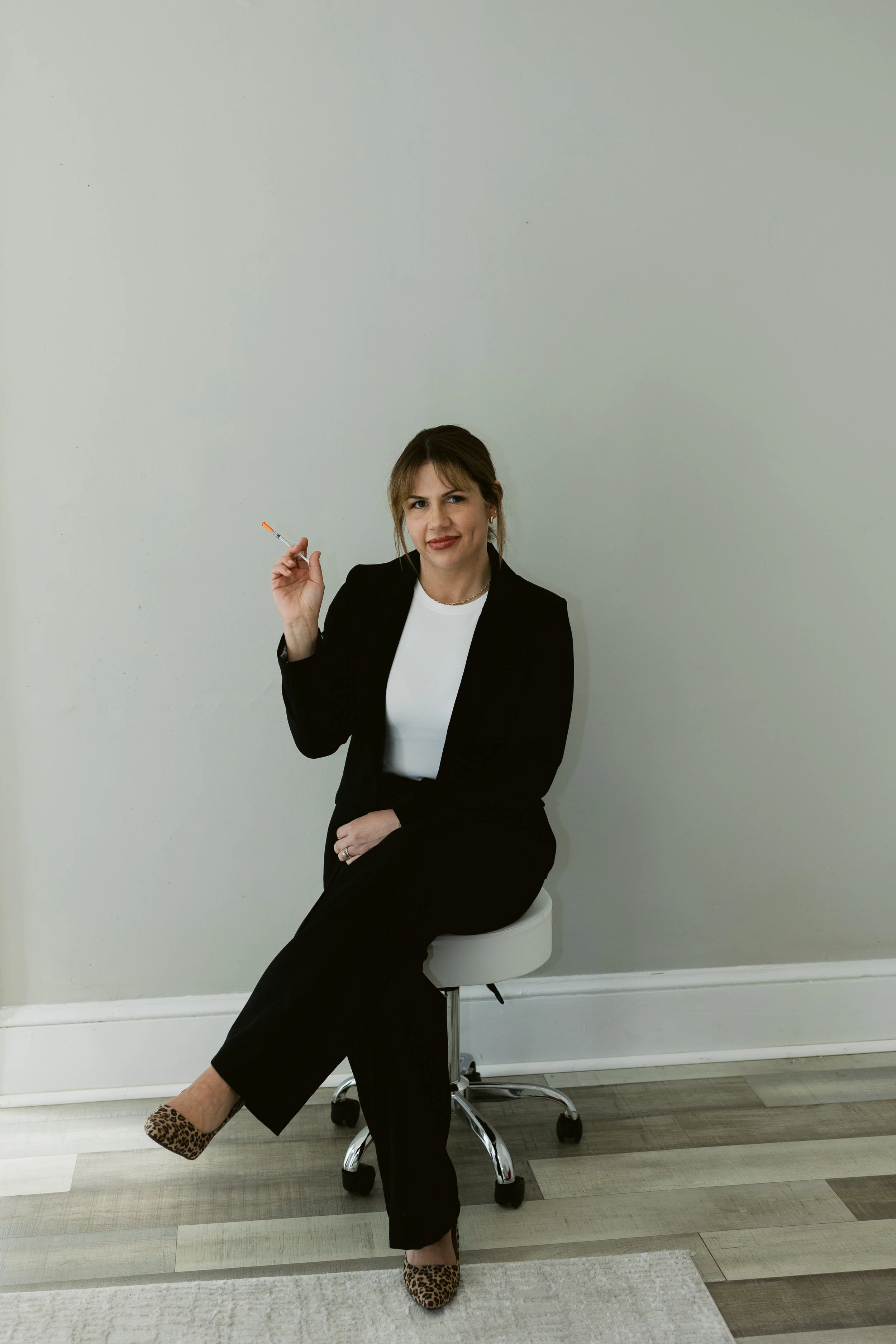 Nichole Boland, RN, founder and aesthetic injector at RAW Rejuvenation Aesthetics & Wellness in Chambersburg, PA, smiling in a clinical treatment room.