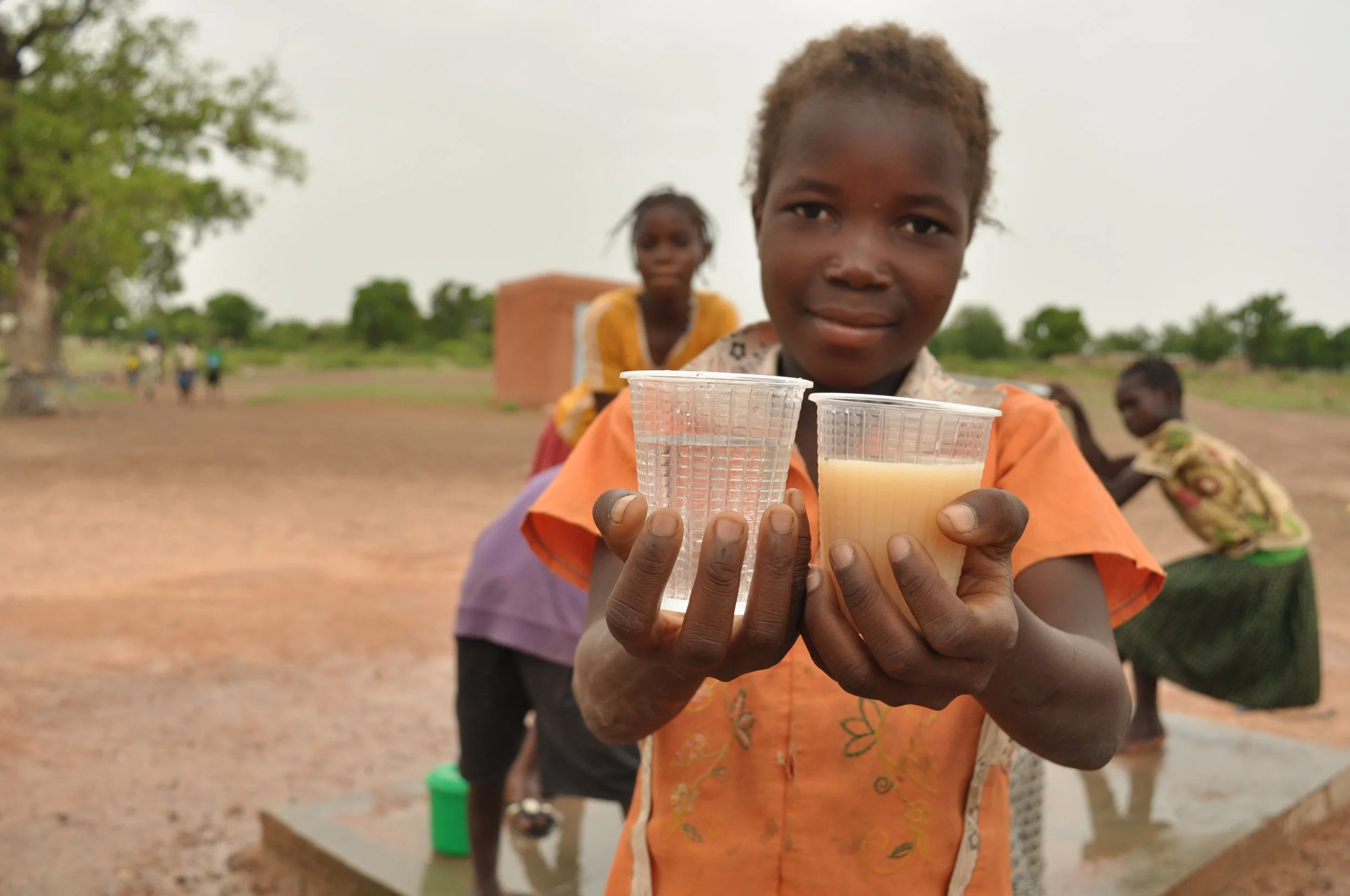 Children collecting water at a new well in Burkina Faso